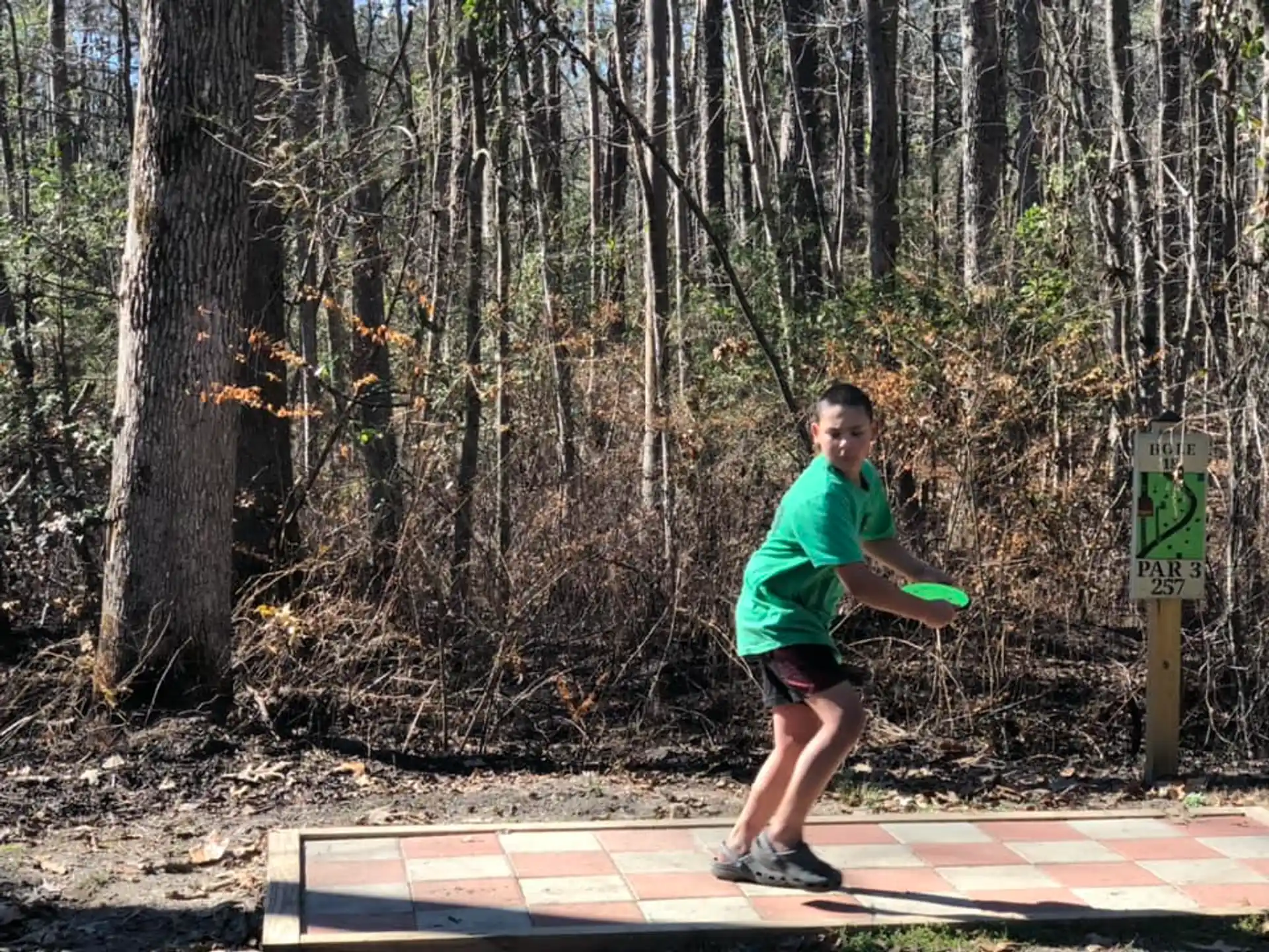 a boy throwing a frisbee