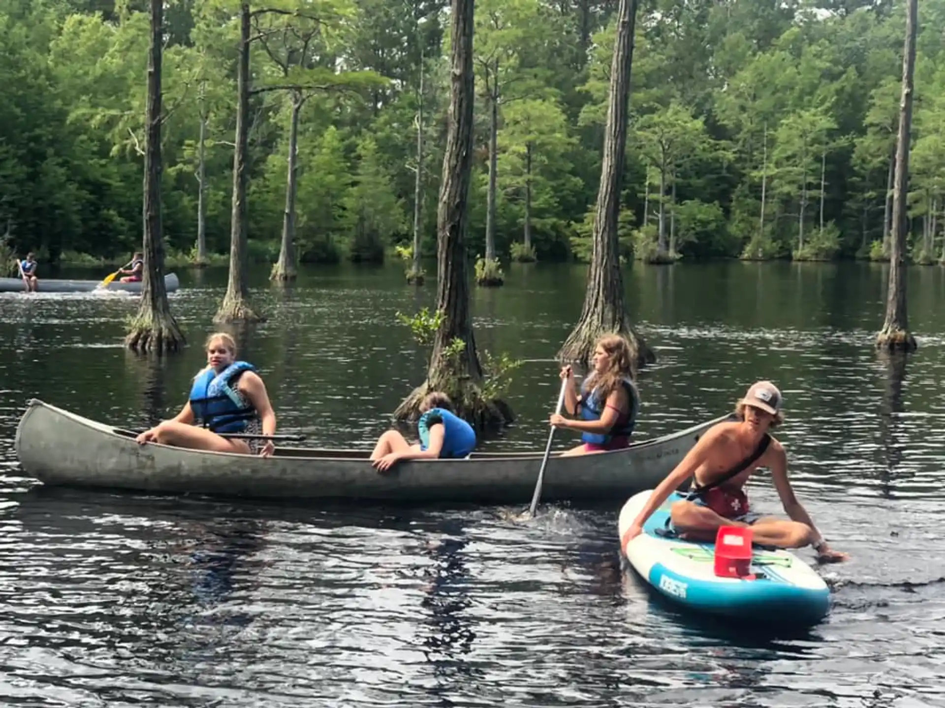 a group of people in canoes on a lake