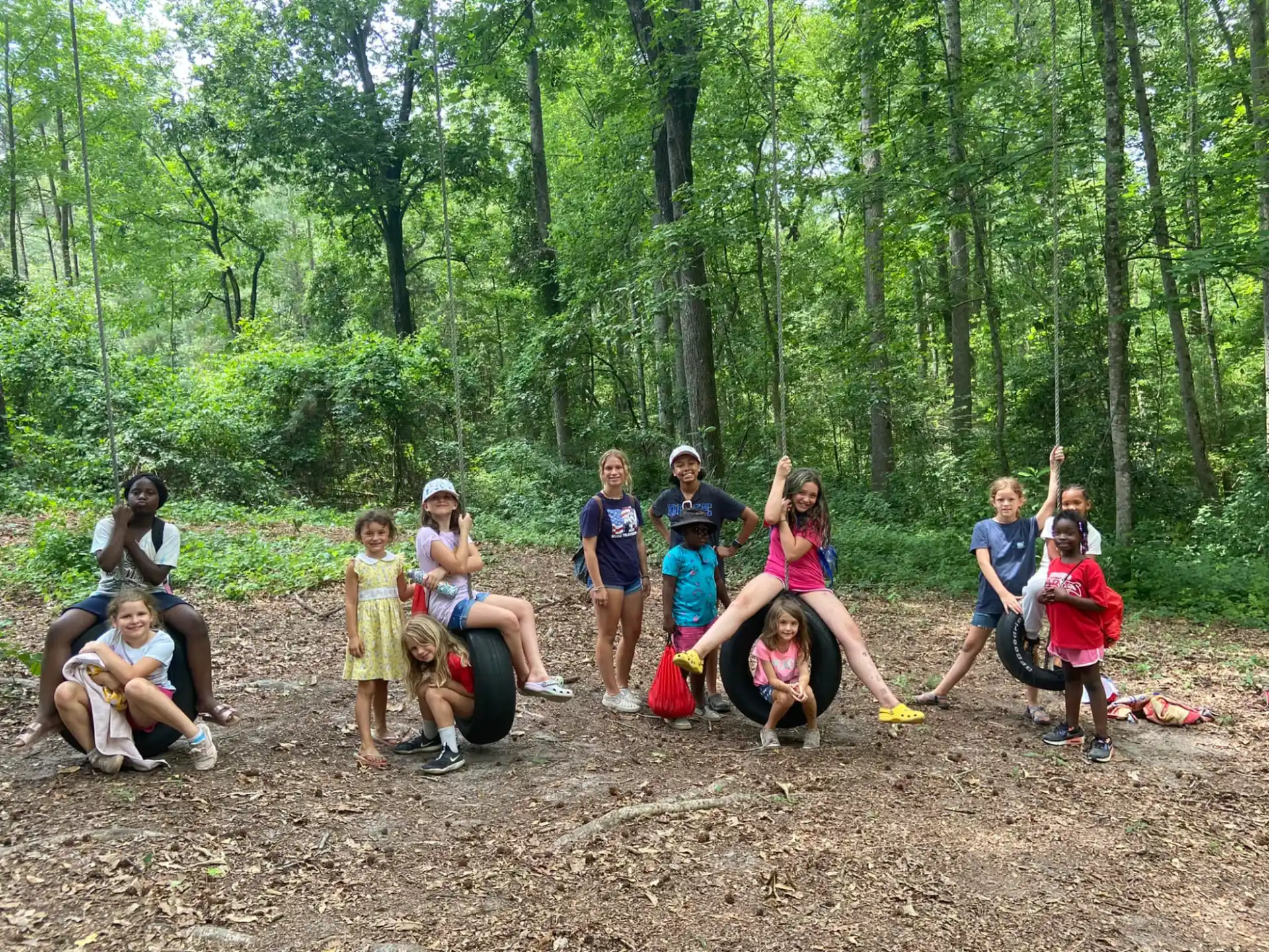 a group of people posing for a photo in the woods