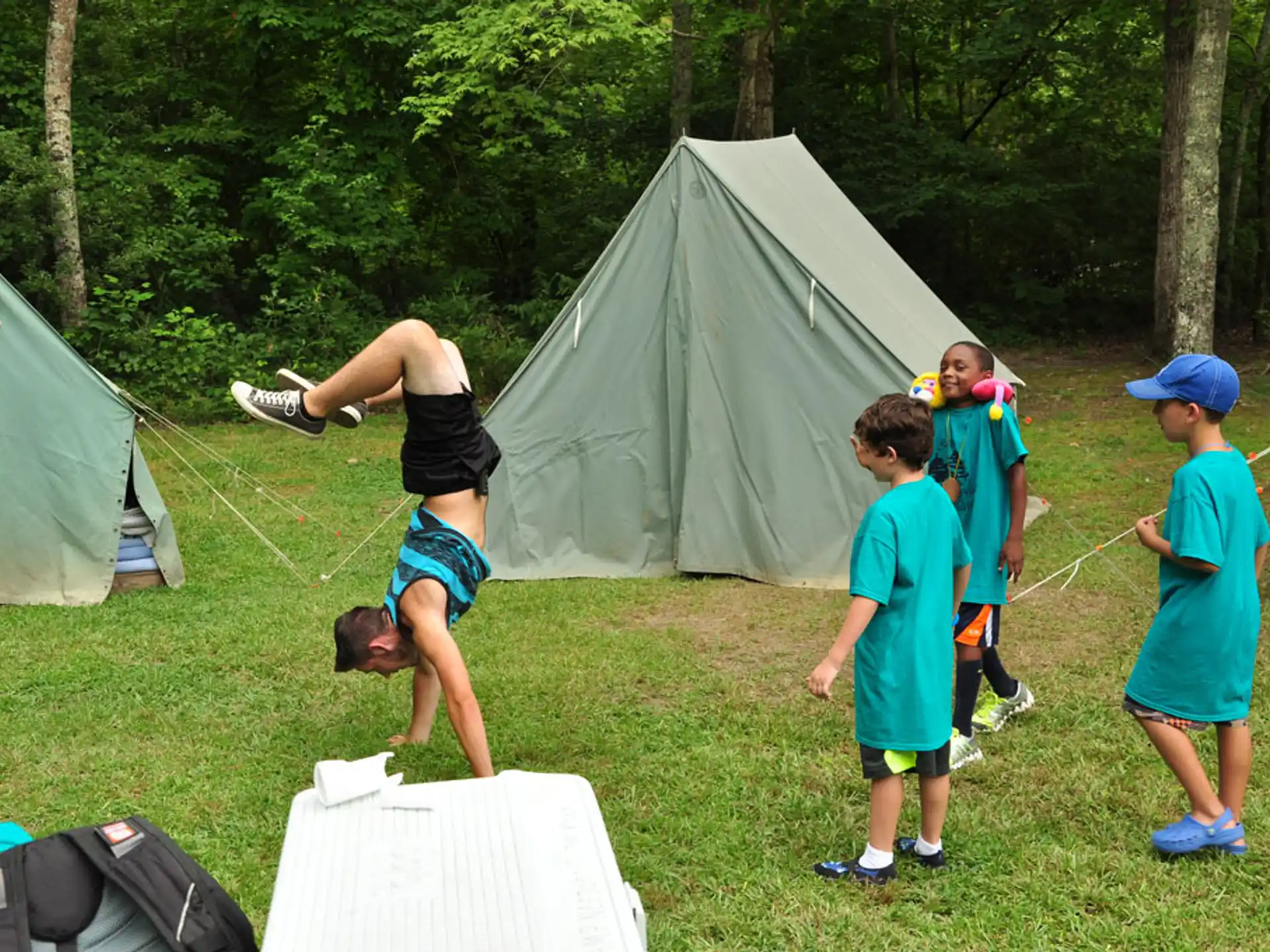 a group of people playing with a person in the air