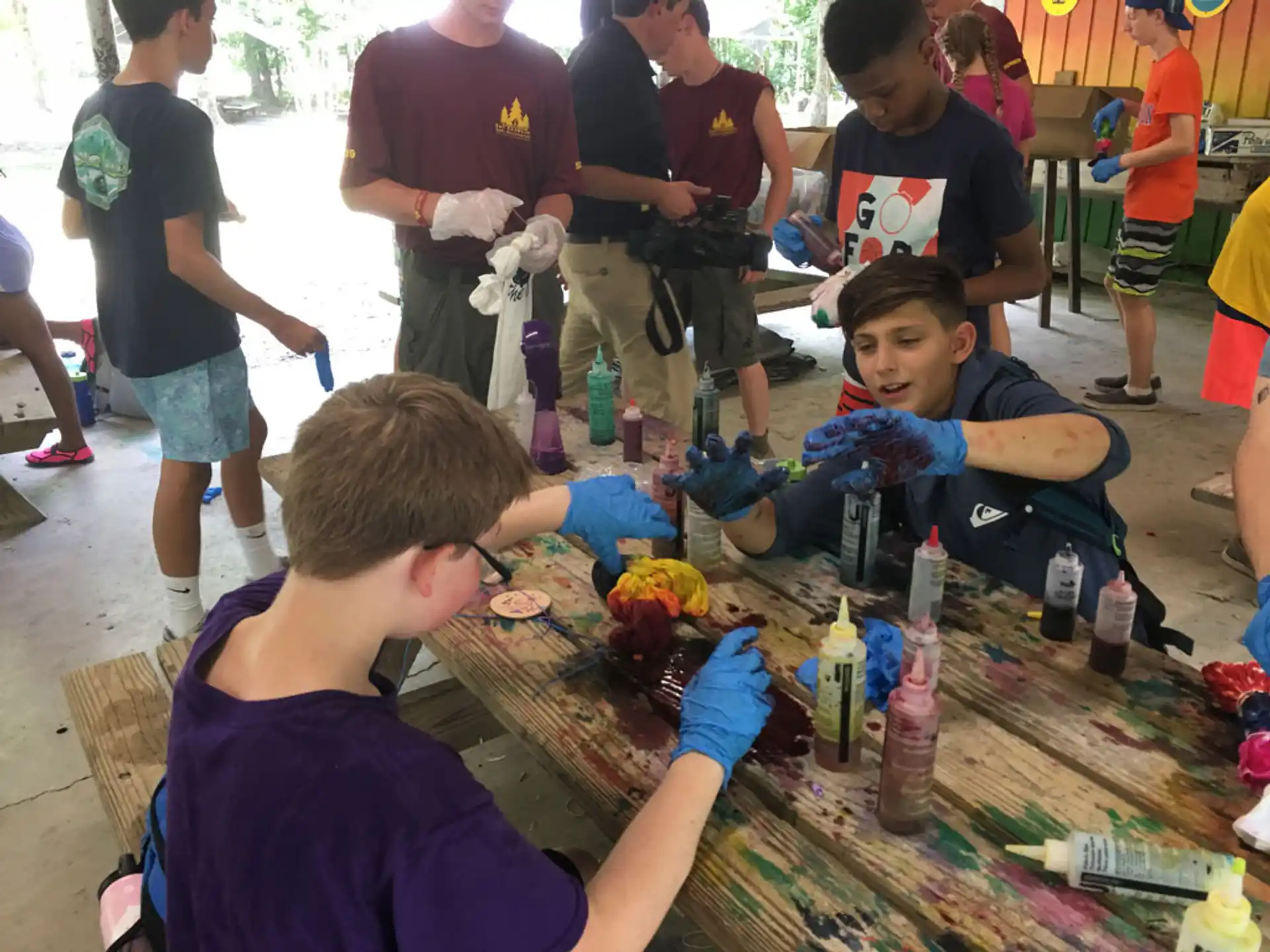a group of people sitting at a table with bottles and cans