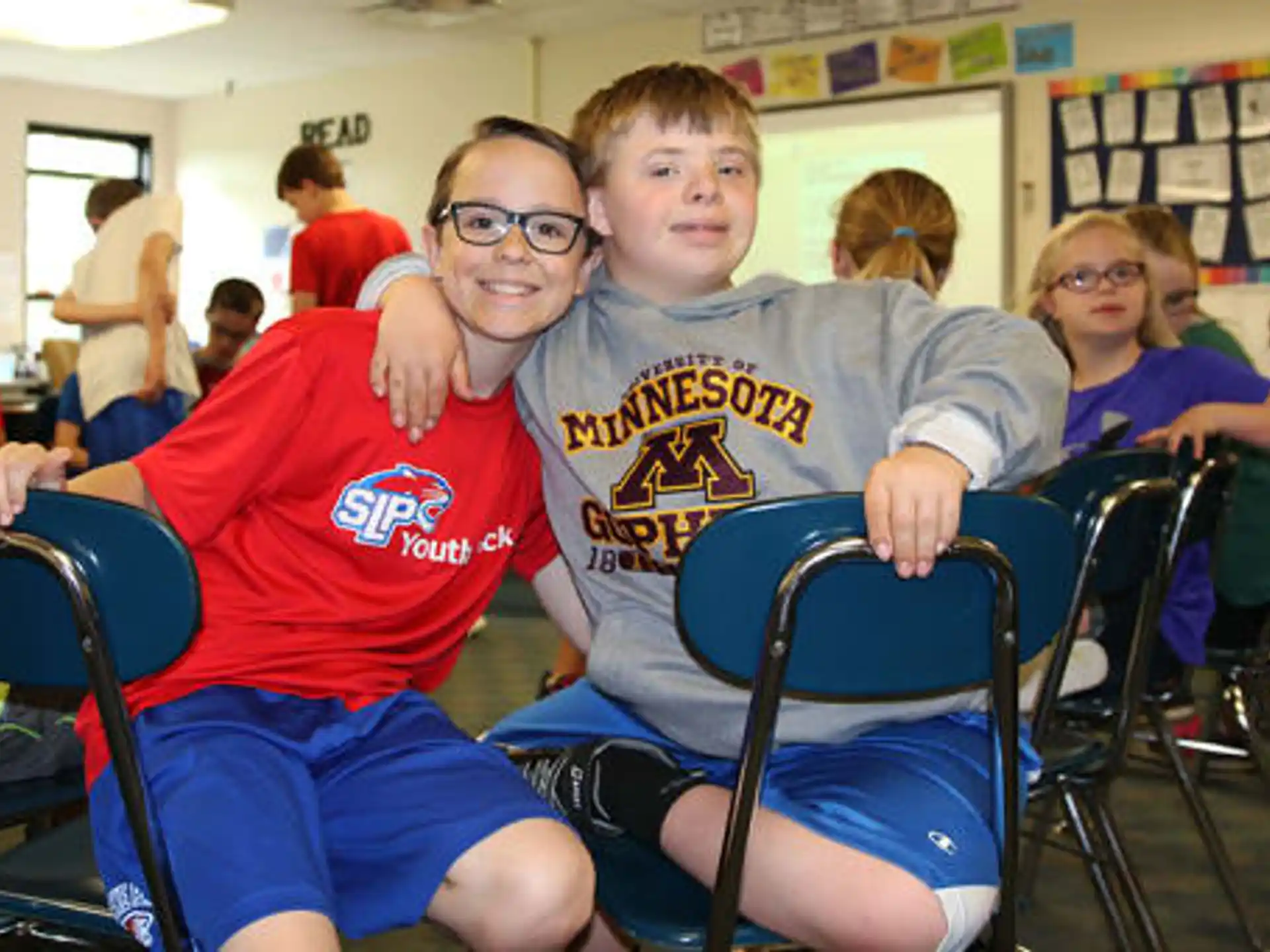 a couple of boys sitting in chairs