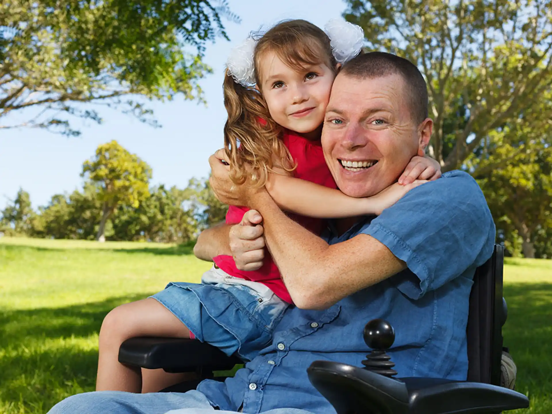 a person and a child on a lawnmower
