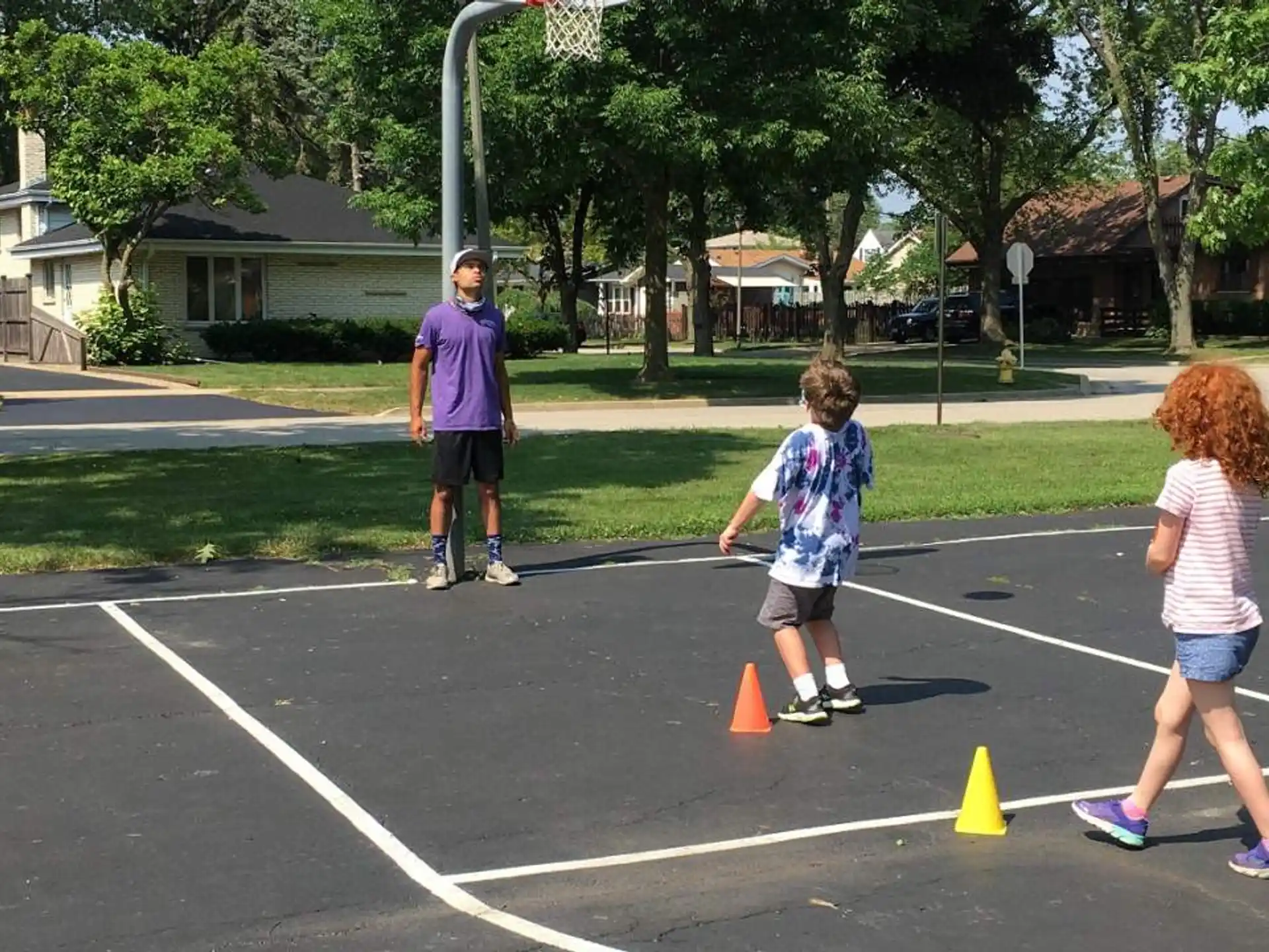 a group of people playing in a parking lot