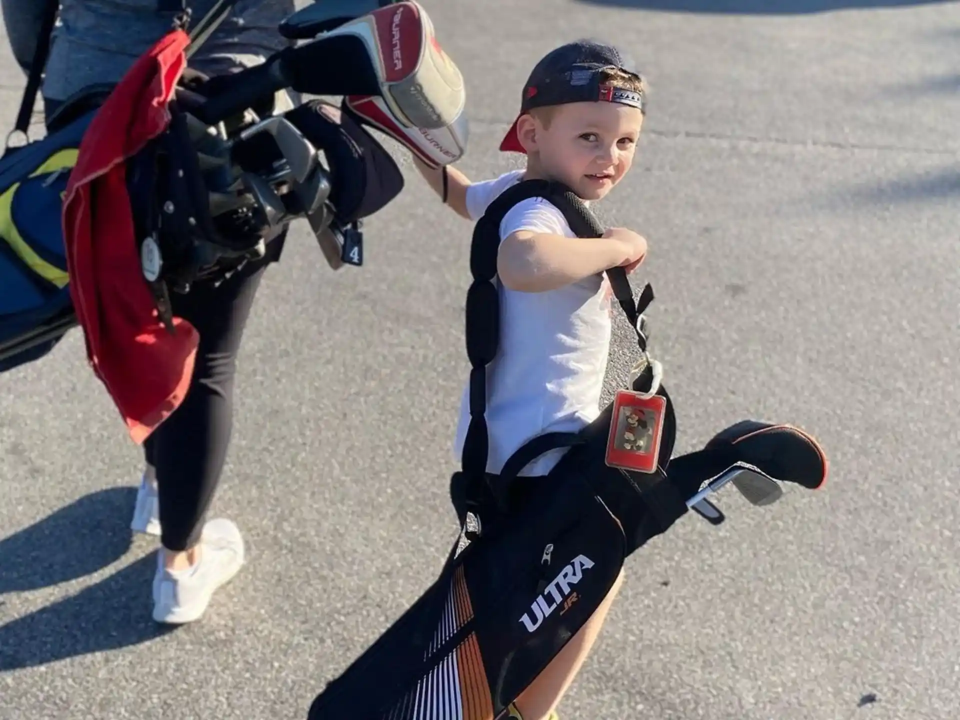 a boy holding a backpack