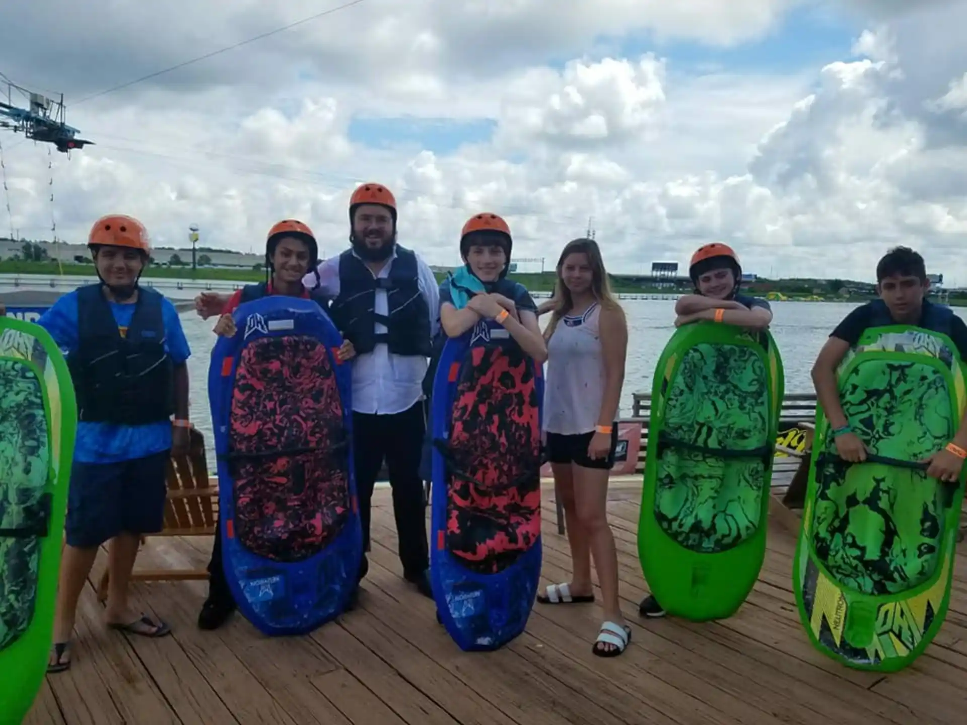 a group of people holding surfboards