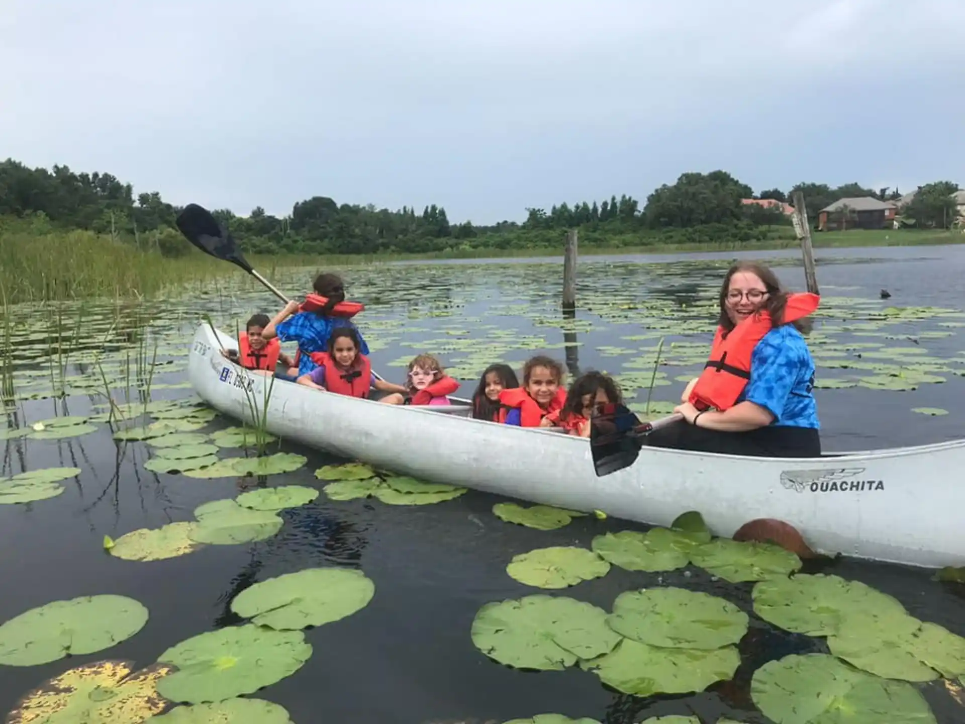 a group of people in a canoe on a lake