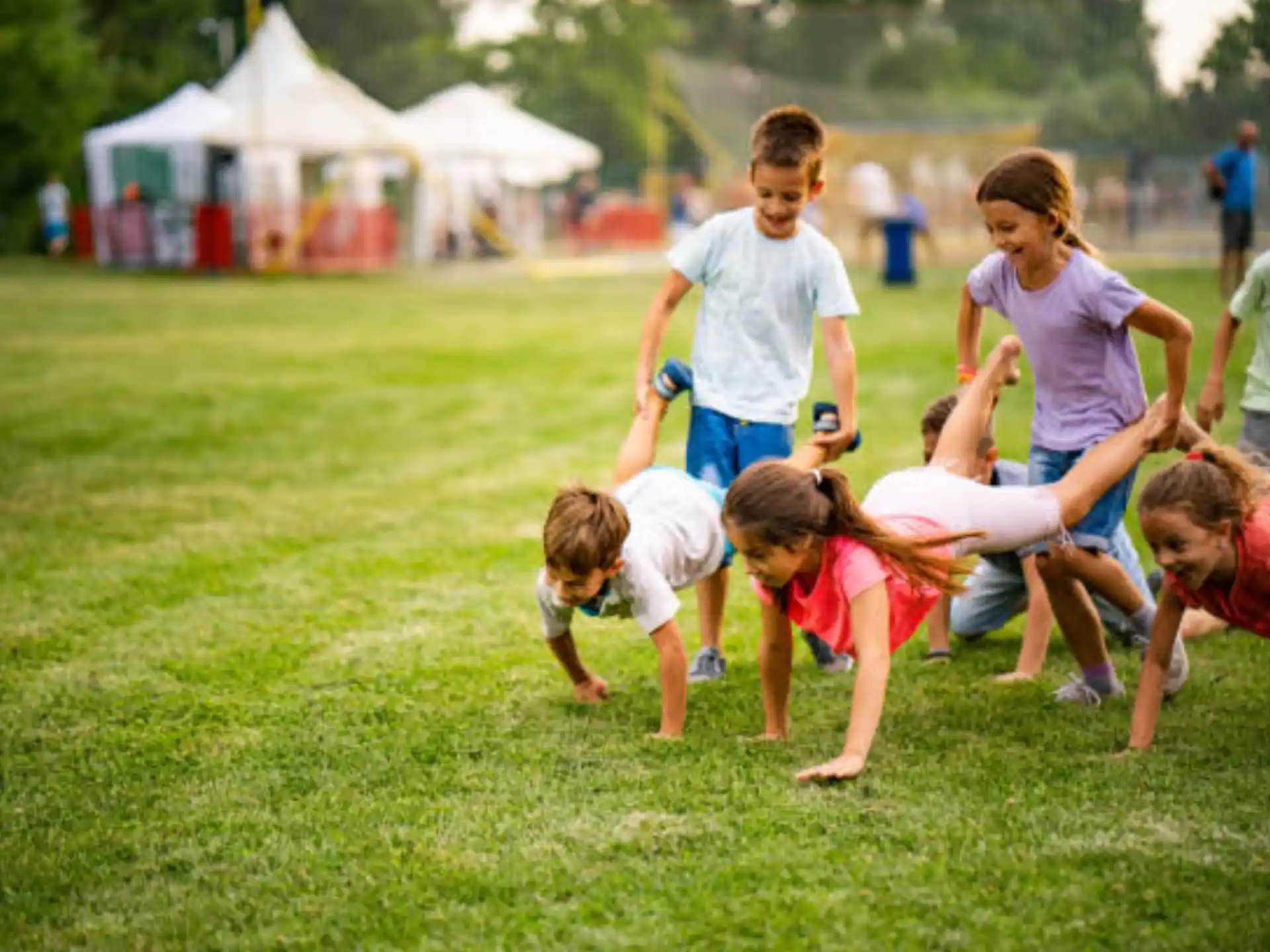 a group of people playing in the grass