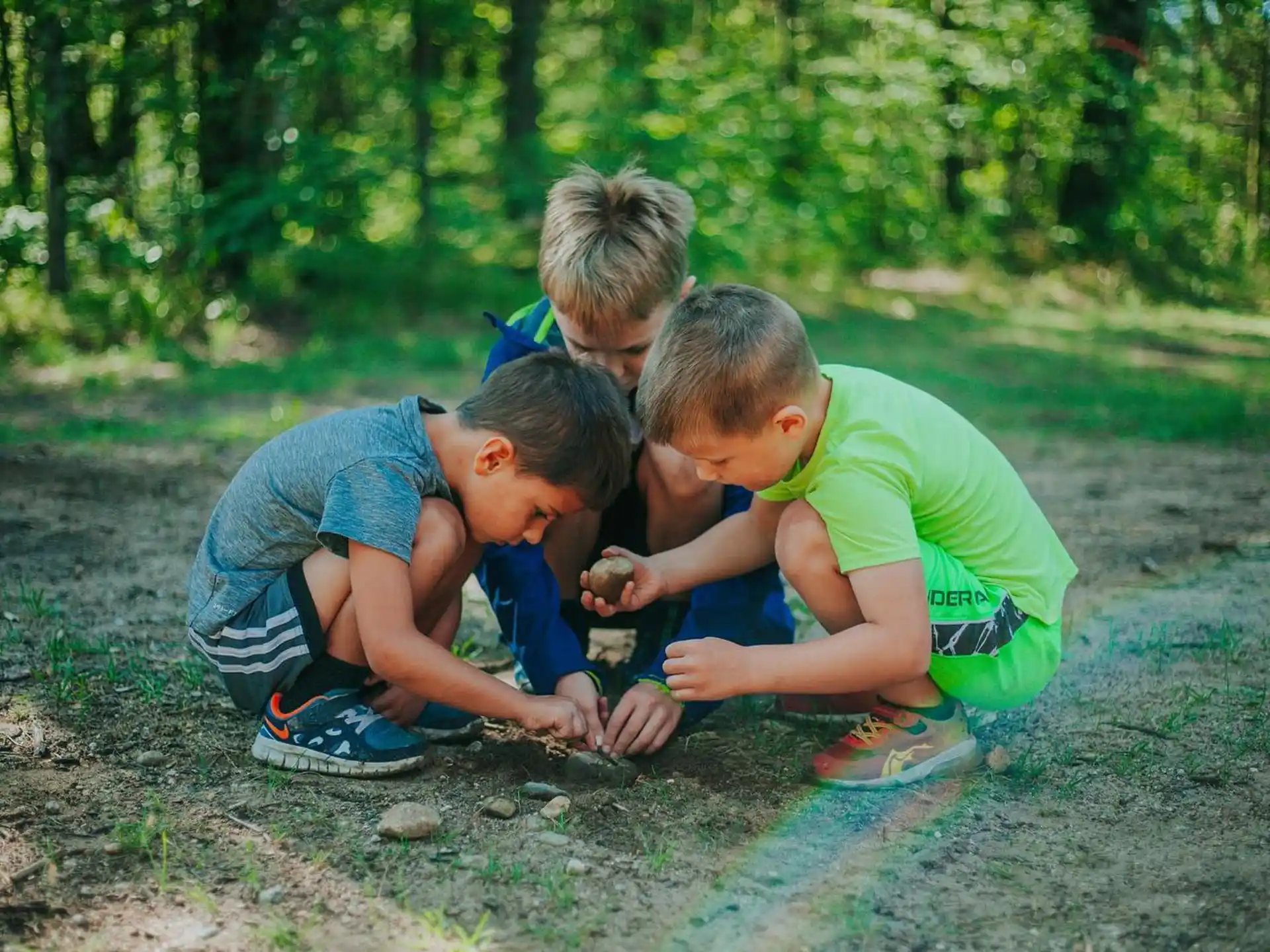 a group of boys playing in the dirt