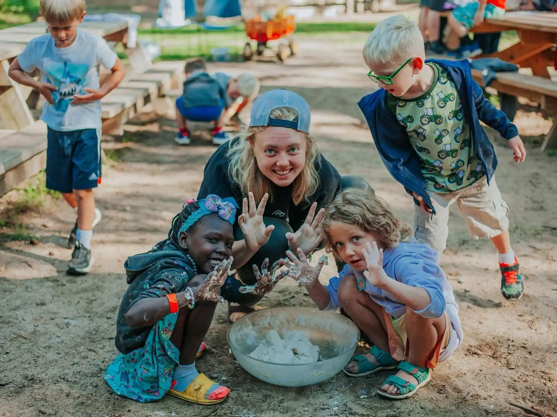 a group of children playing in the dirt