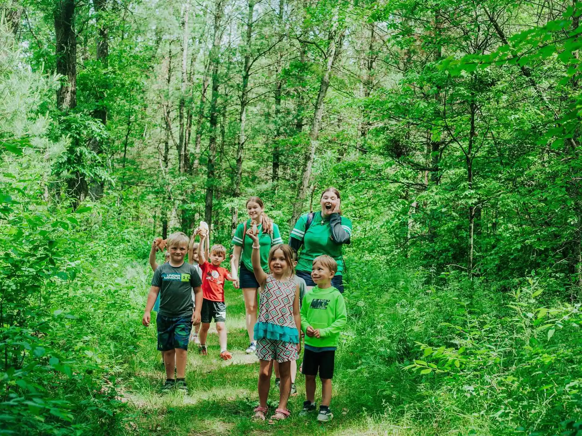 a group of people posing in the woods
