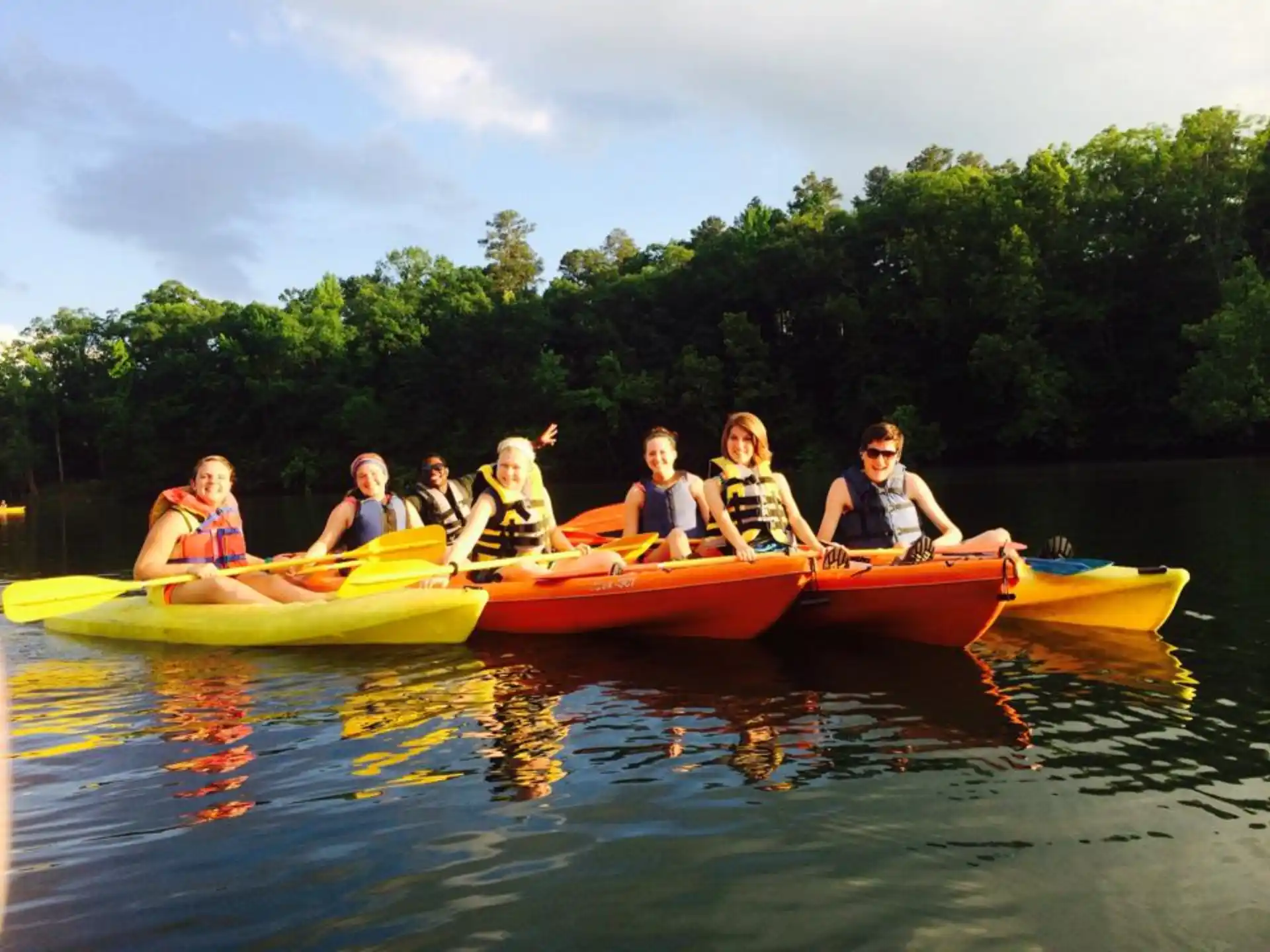 a group of people in canoes on a lake