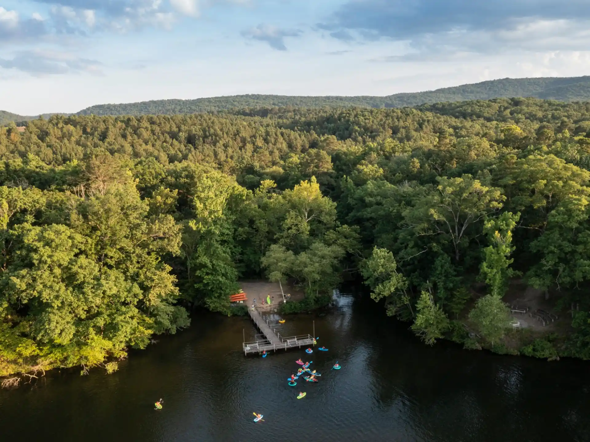 a river with trees and a dock