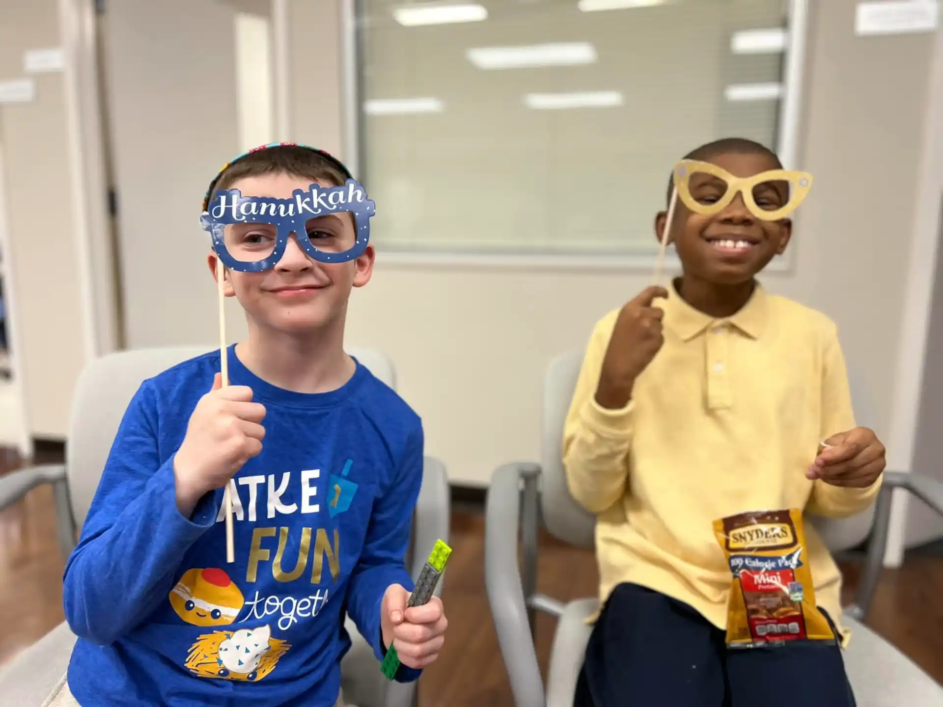 a couple of boys wearing masks and holding tooth brushes