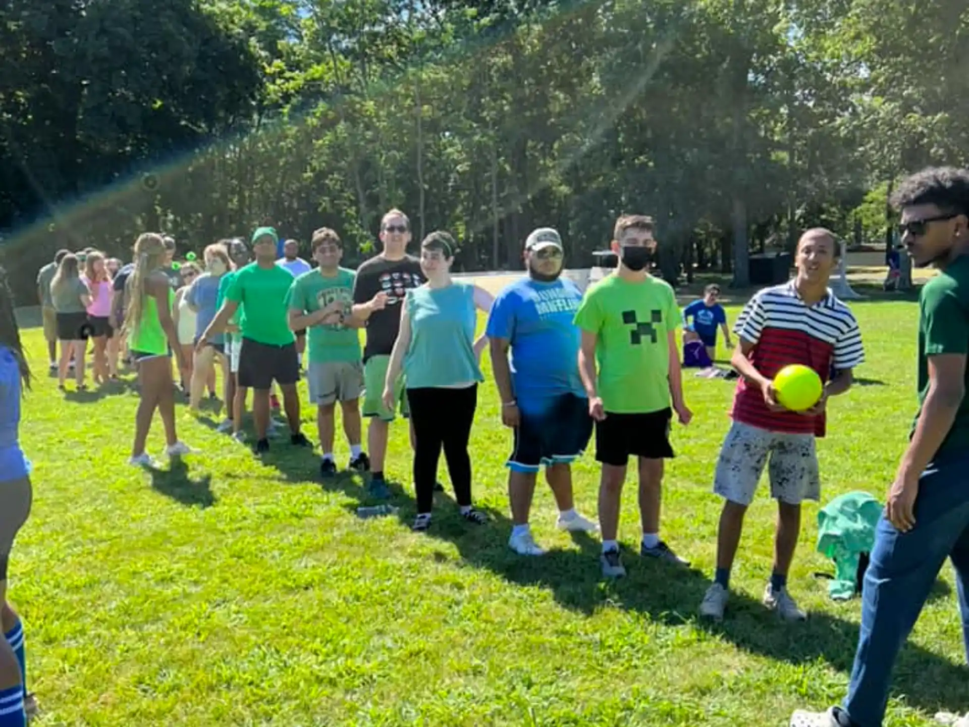 a group of people walking on a path with balls