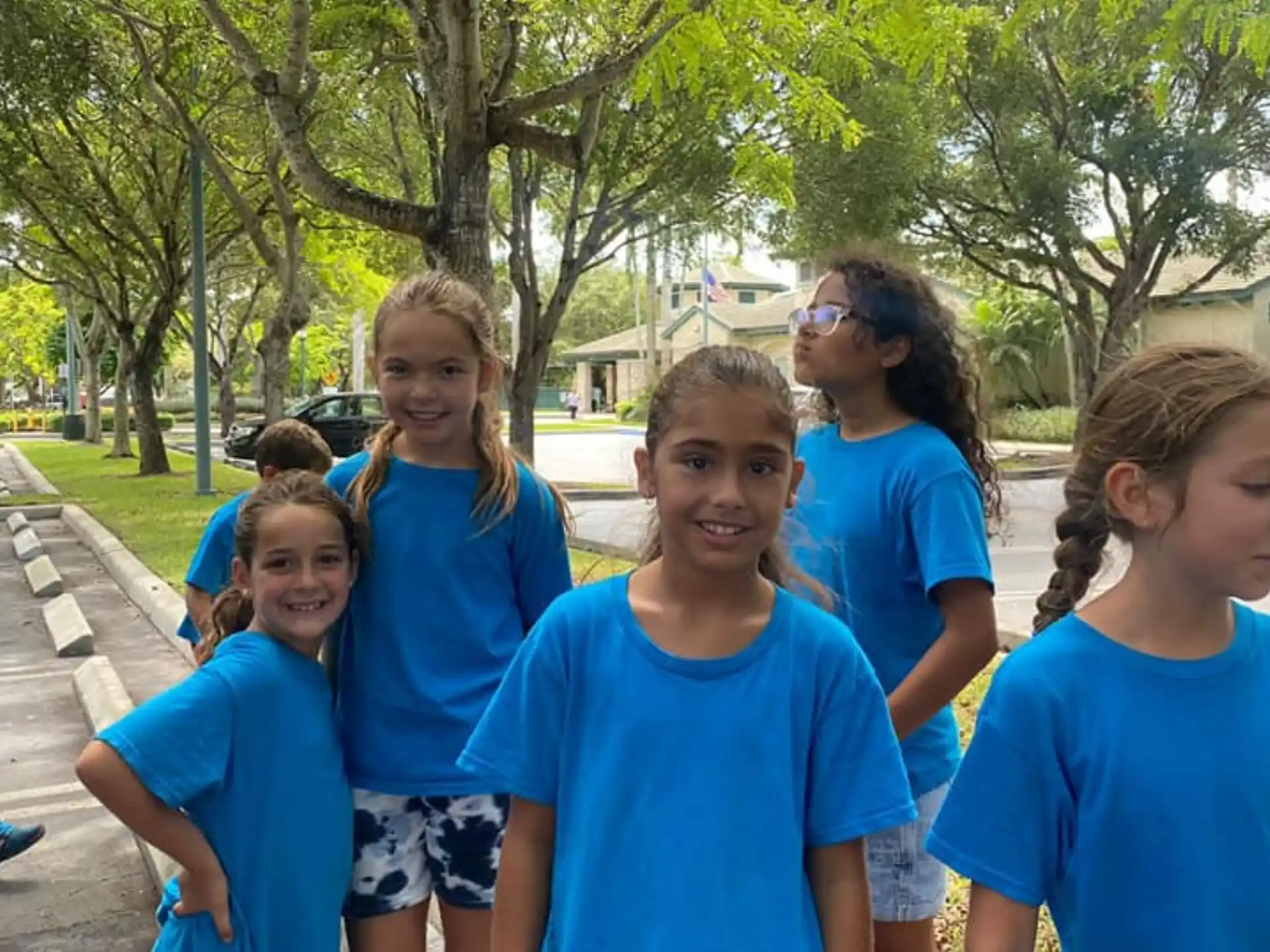 a group of children in blue shirts
