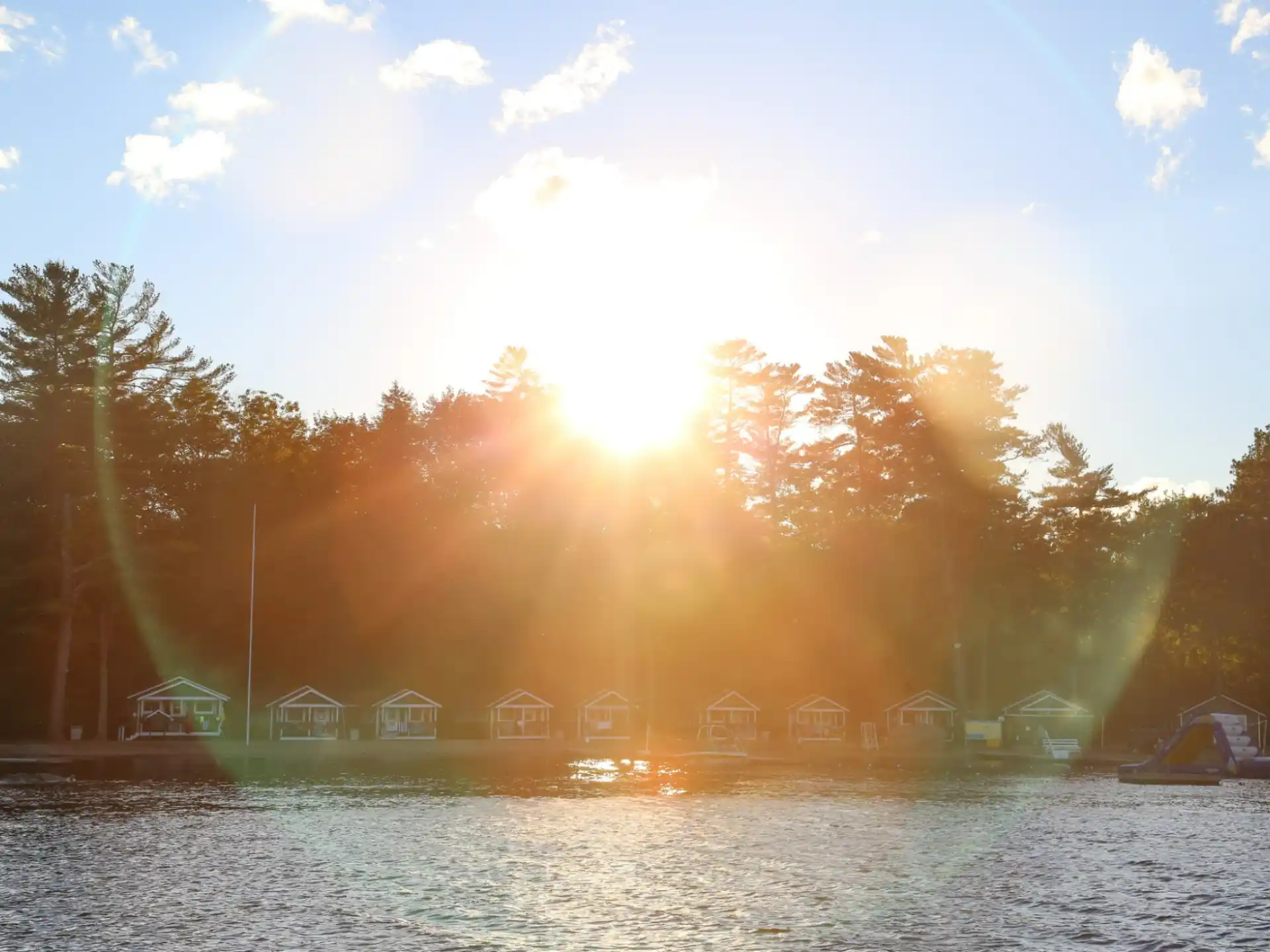 a body of water with trees and buildings in the background