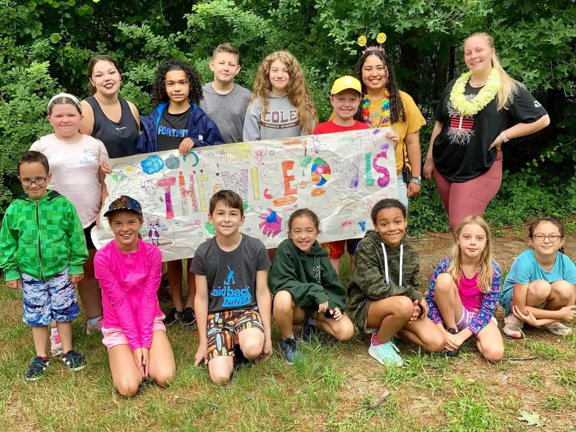 a group of children holding a banner