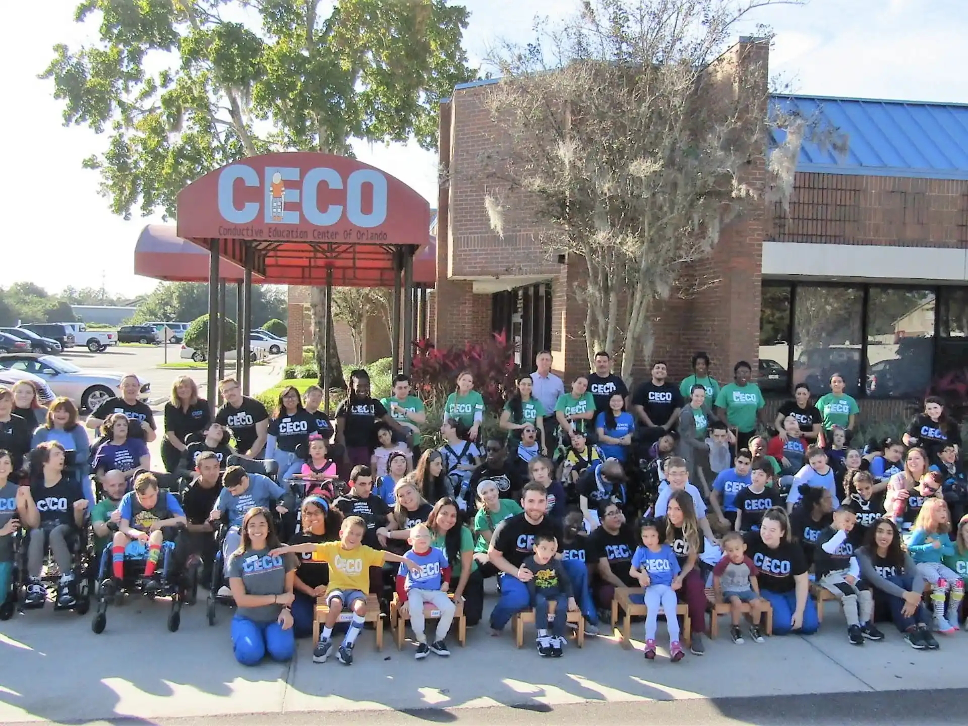 a group of people posing for a photo in front of a building