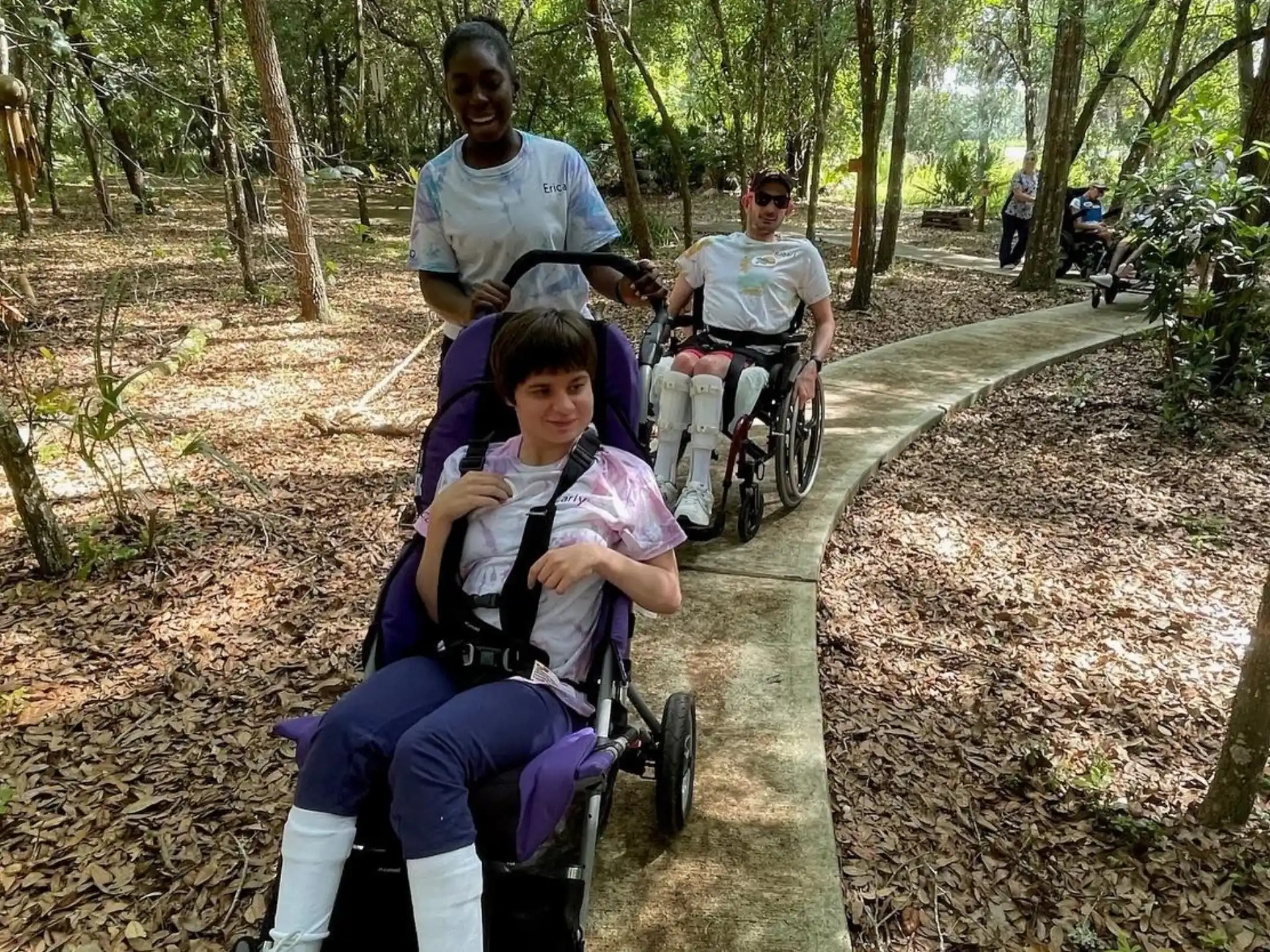a group of people riding on a bicycle in a park