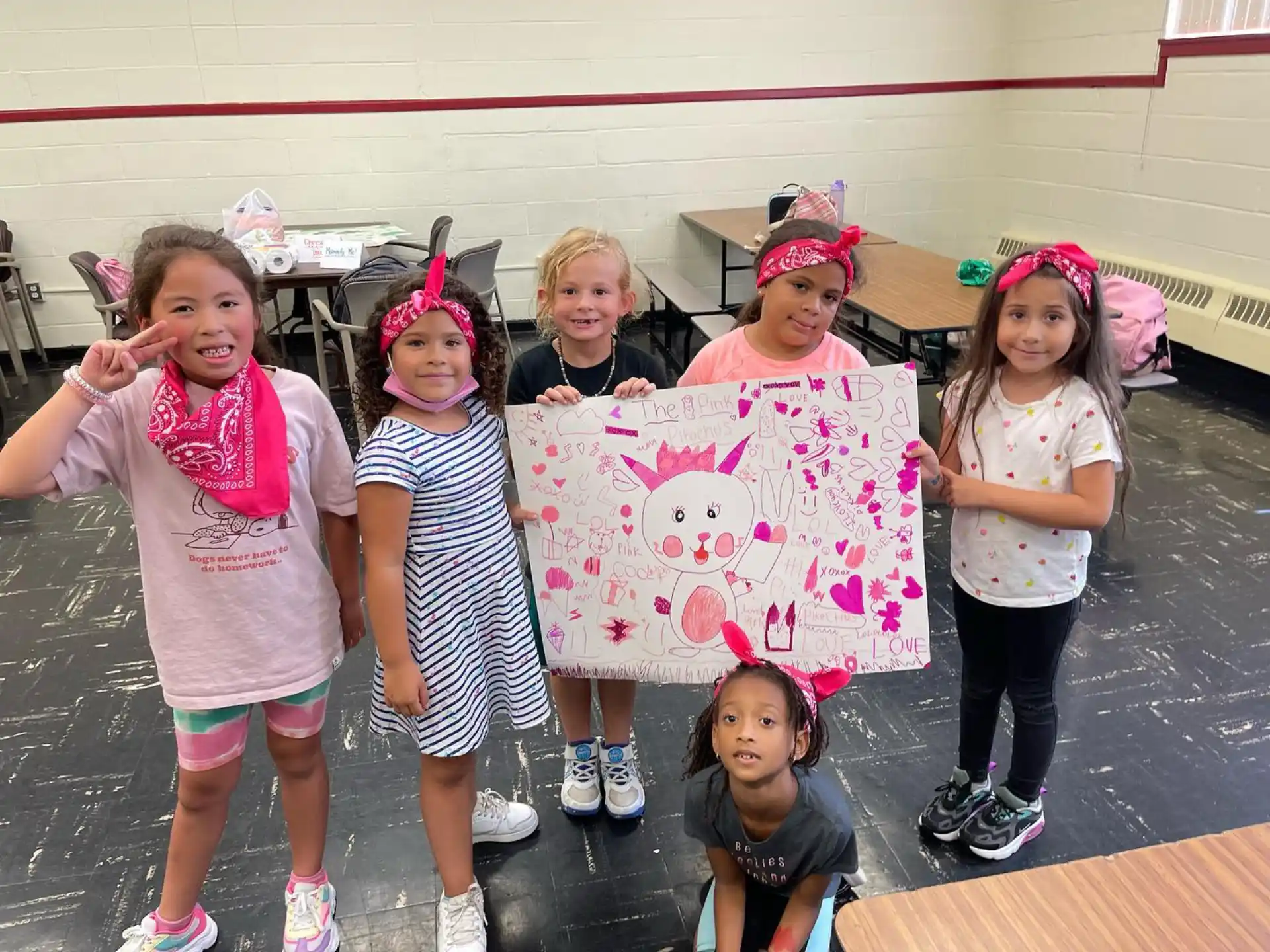 a group of girls holding a sign