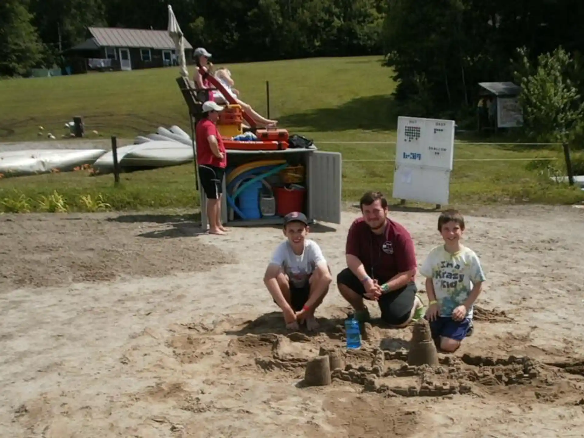 a group of people sitting in the sand