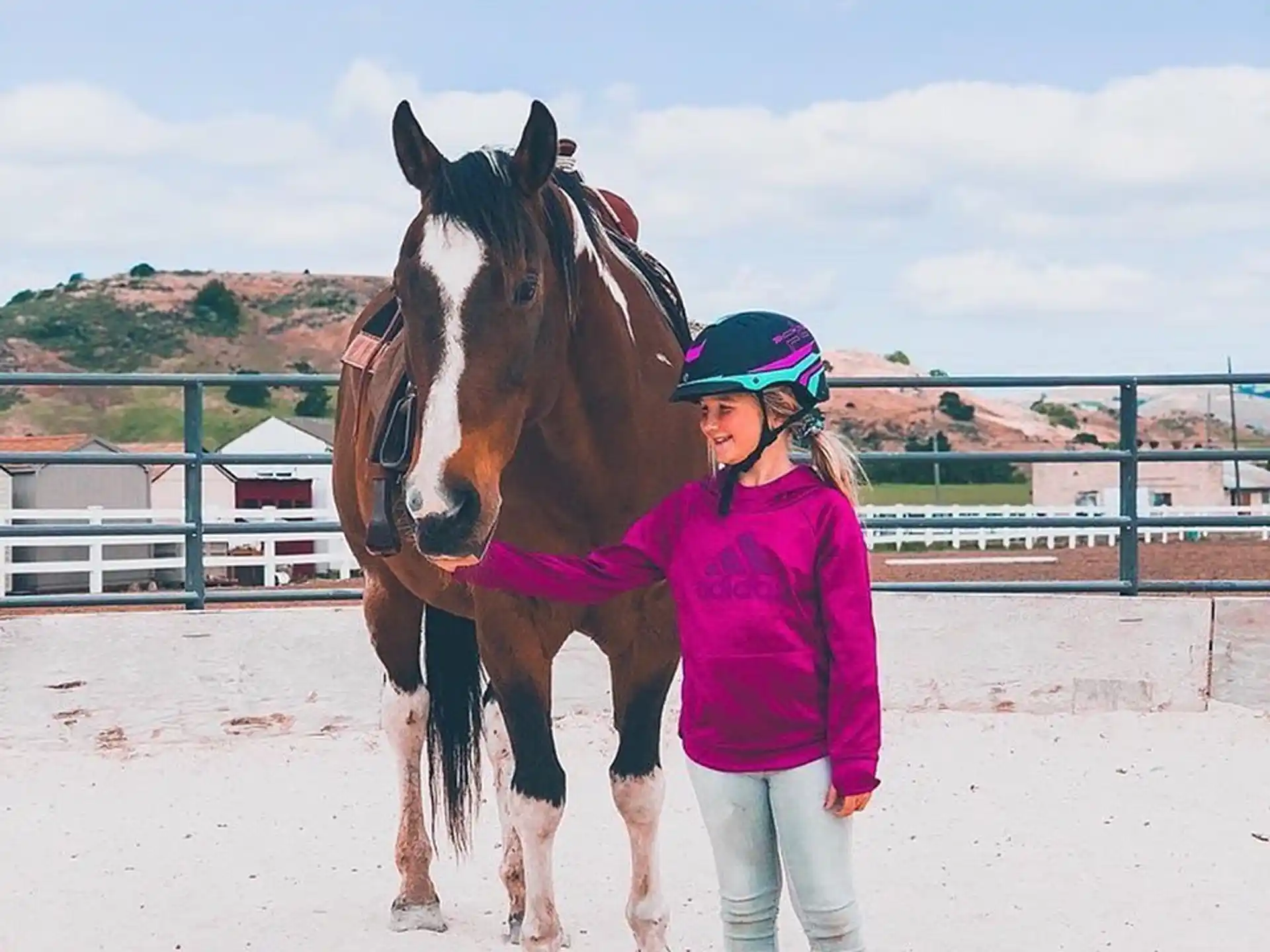 a person standing next to a horse