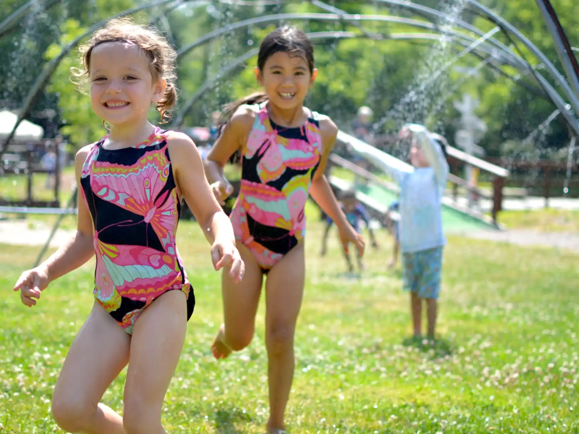 a couple of girls running on a playground
