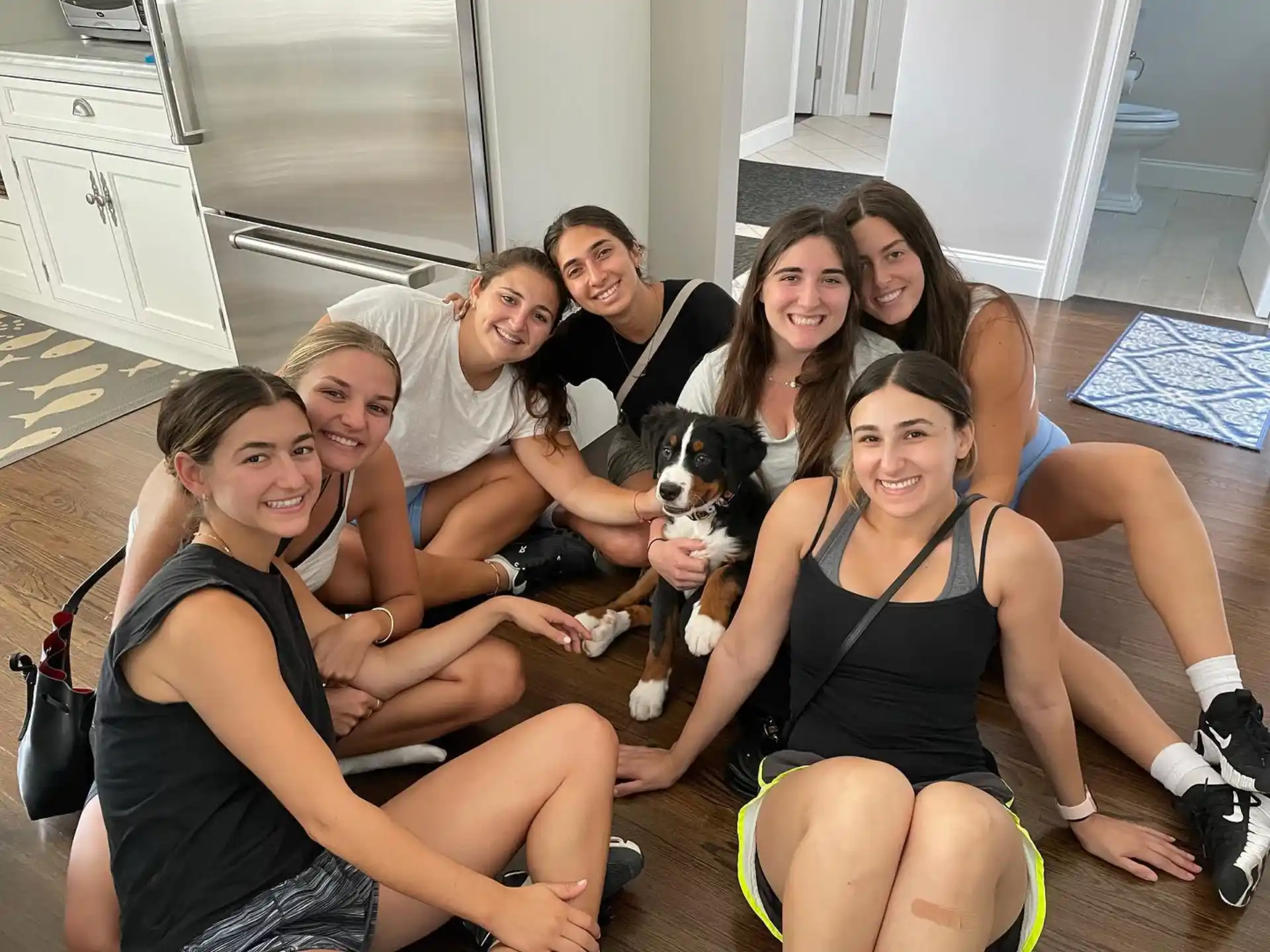 a group of people sitting on a boat with a dog