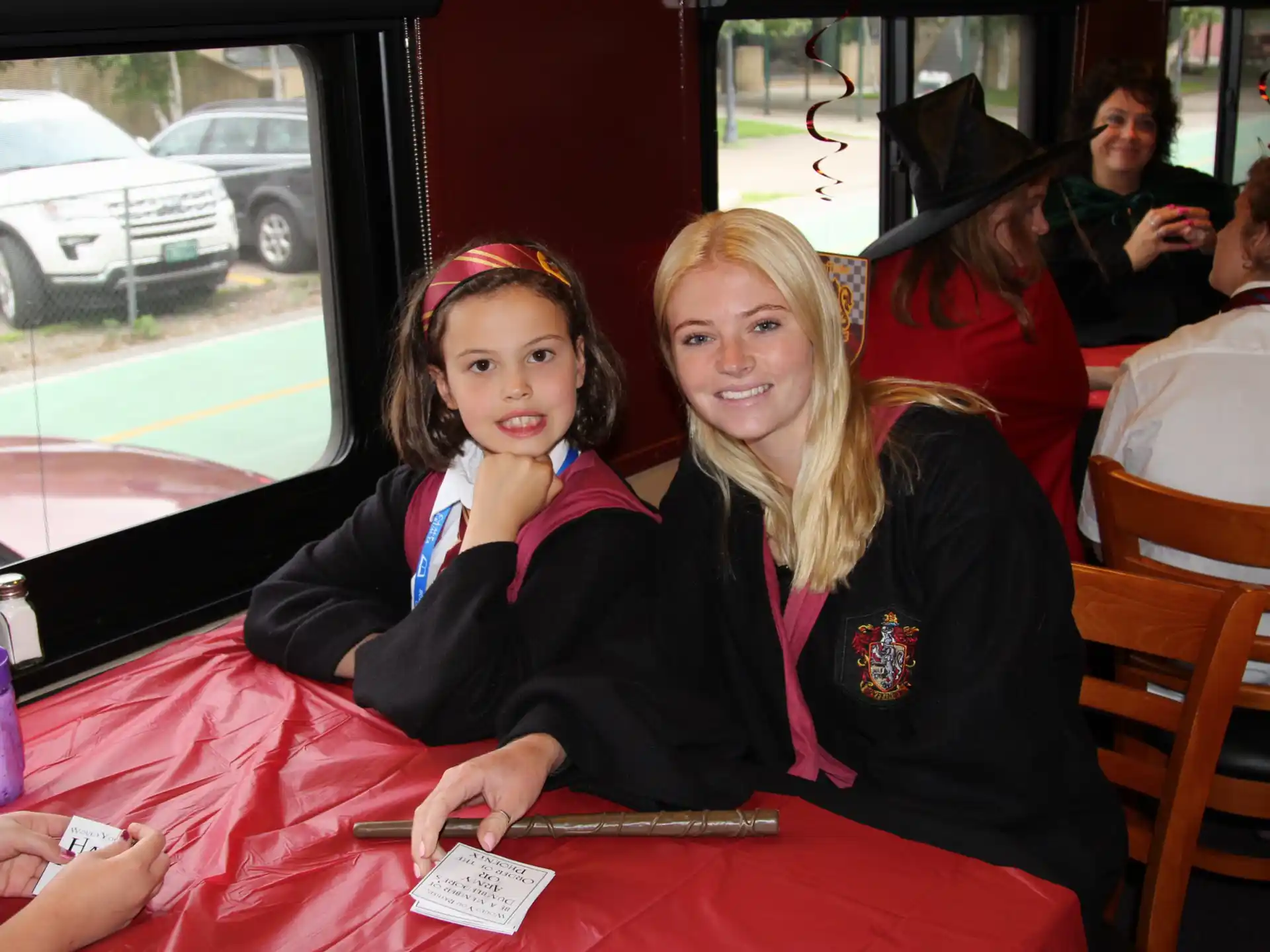 a couple of girls sitting at a table