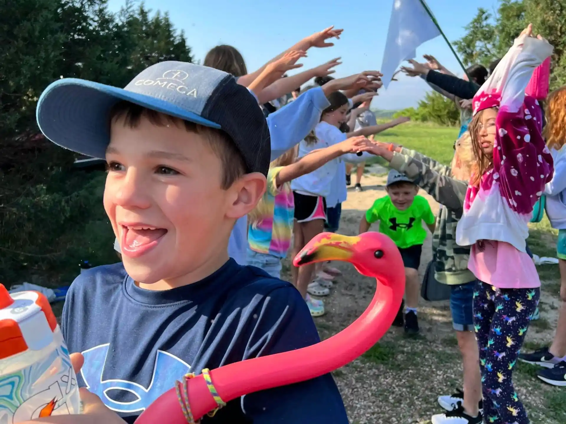 a boy with a hat and a fish in his hand