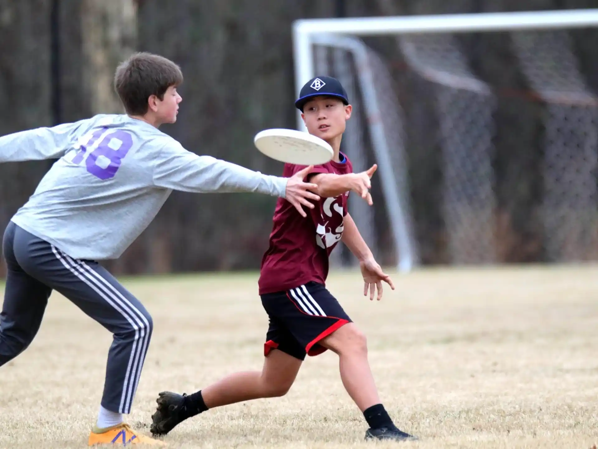 a person and a boy playing frisbee