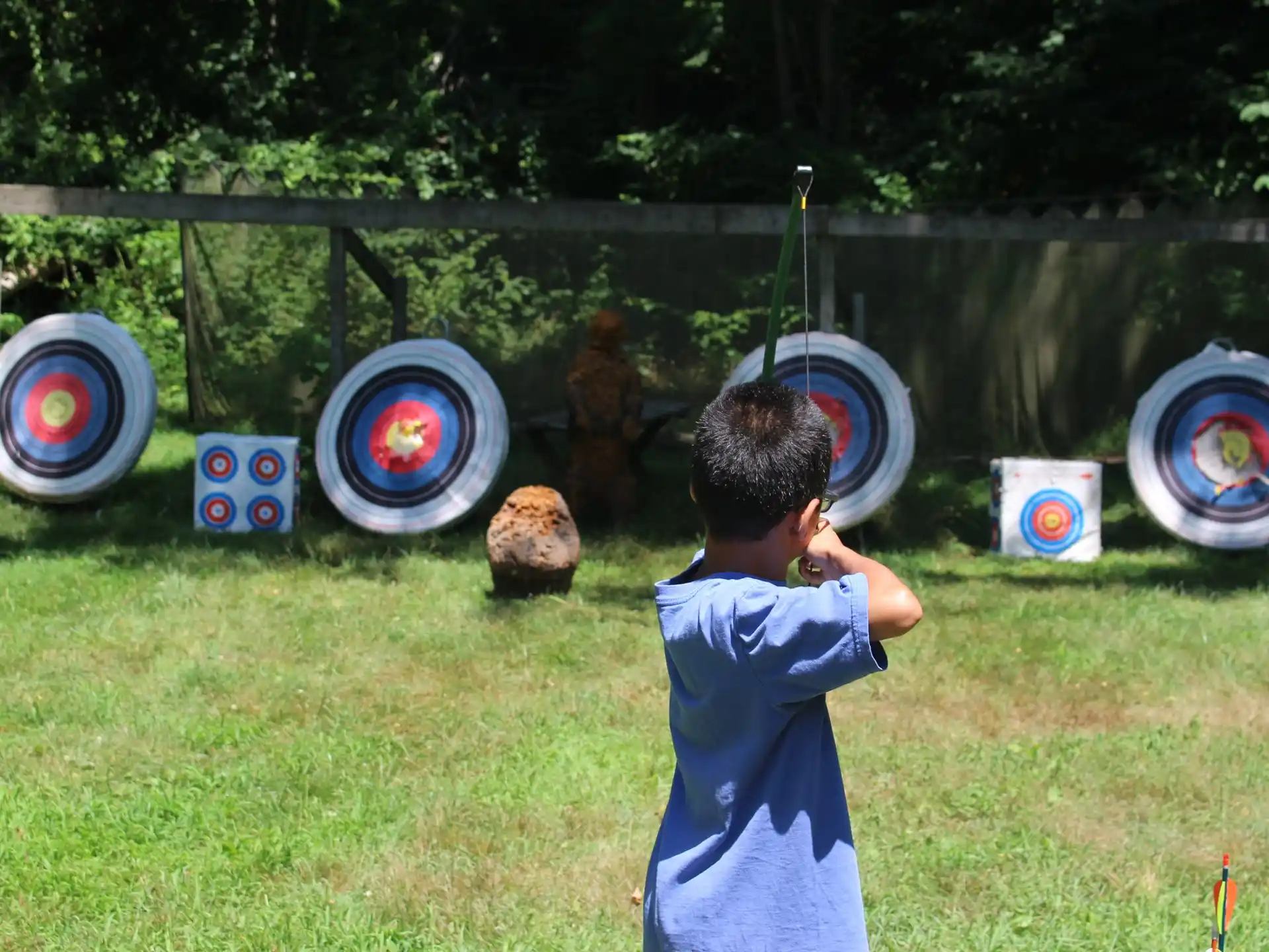 a boy holding a bow and arrow