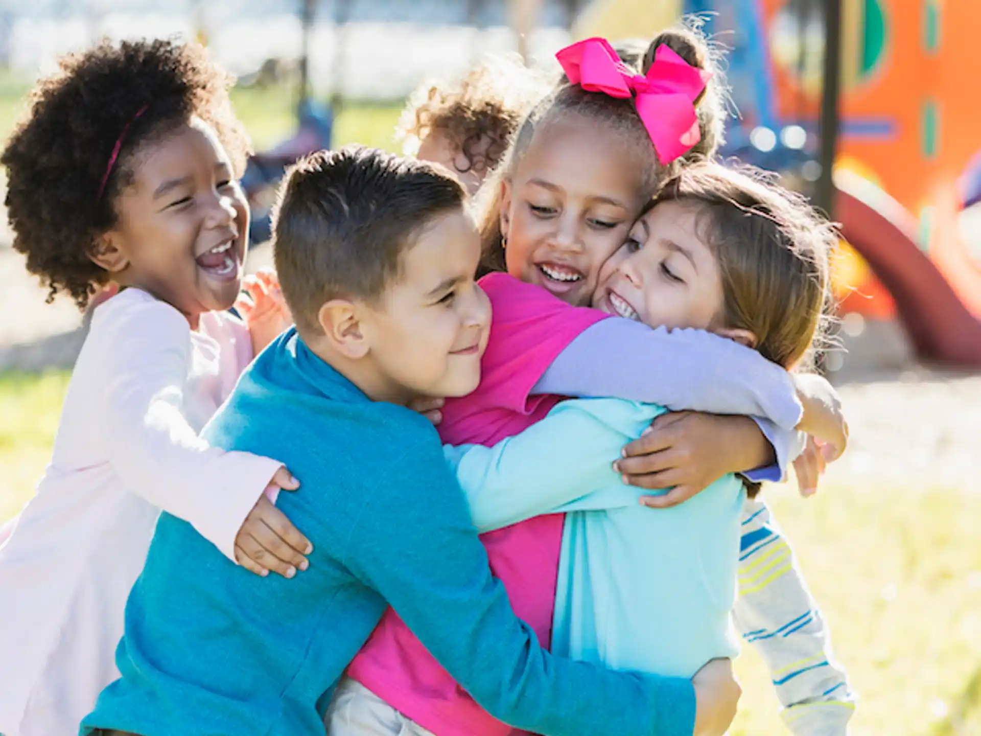 a group of children hugging