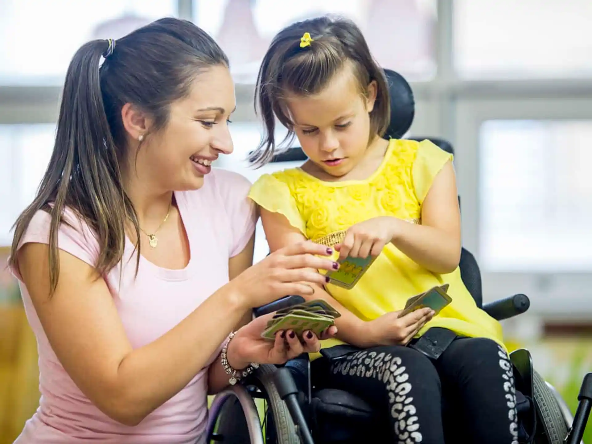 a person and a child looking at a cell phone
