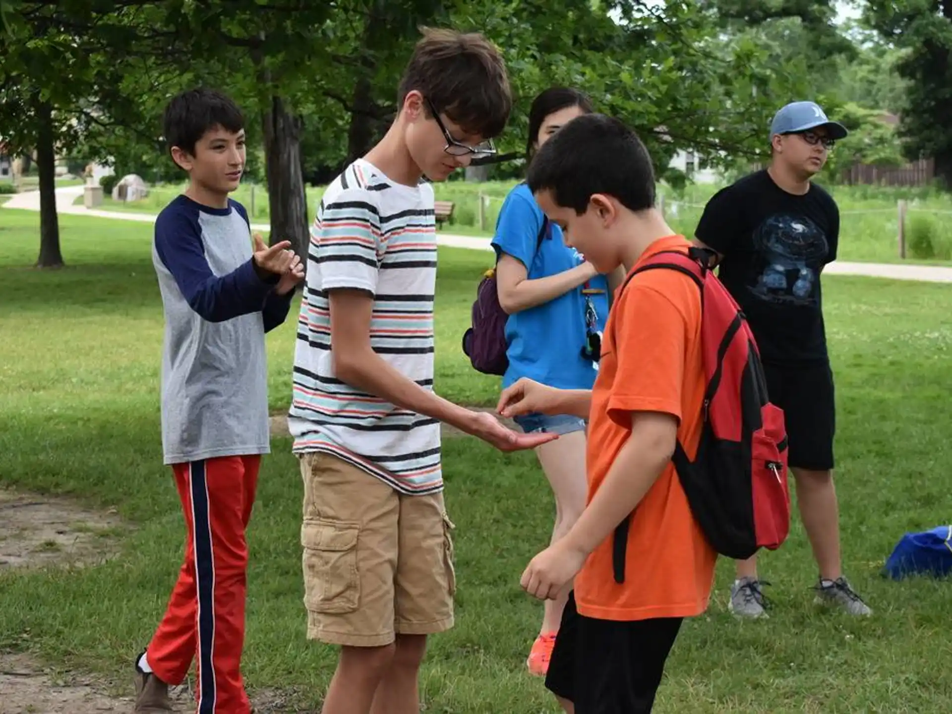 a group of boys standing in a park