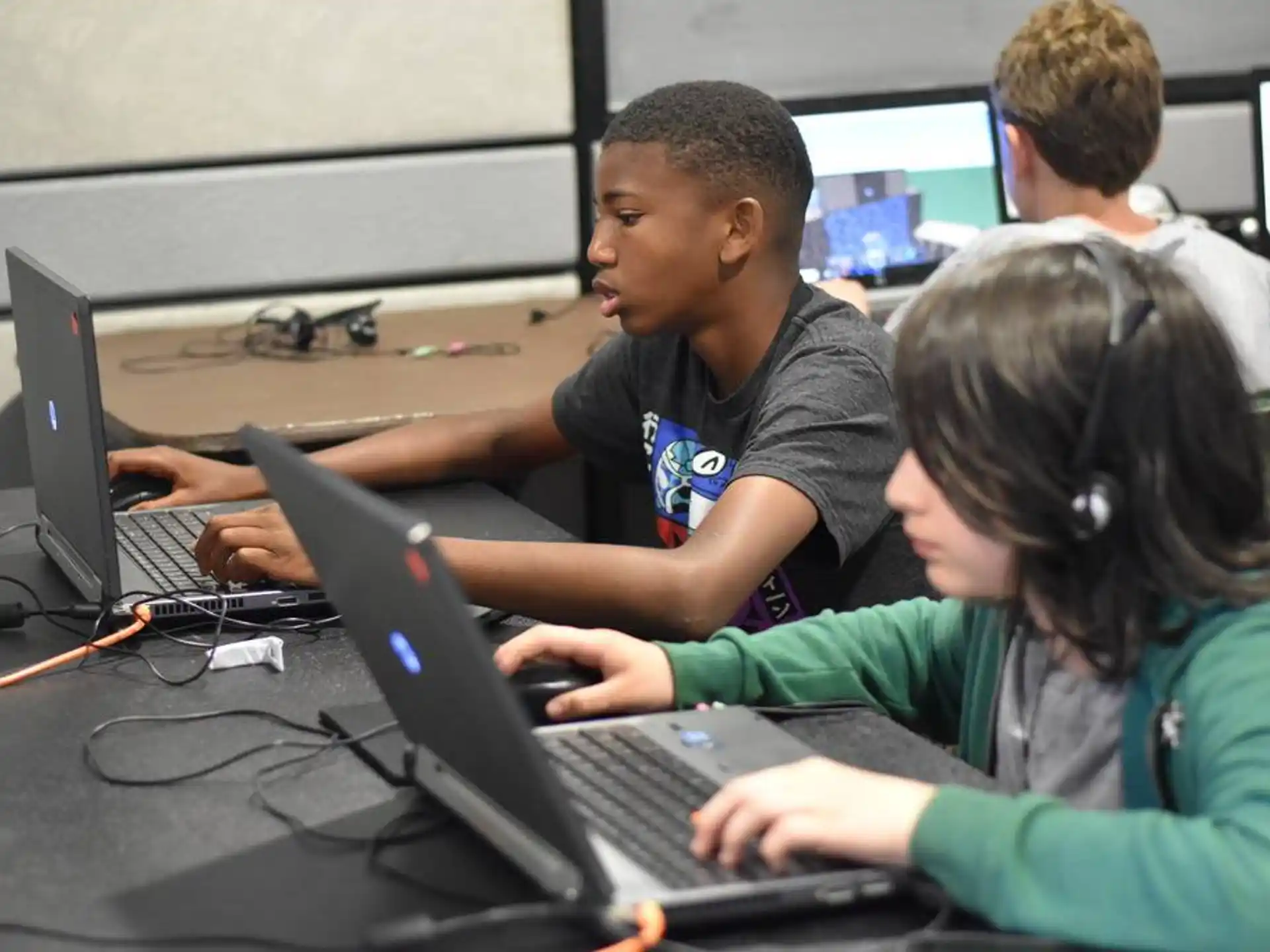 a group of people using laptops