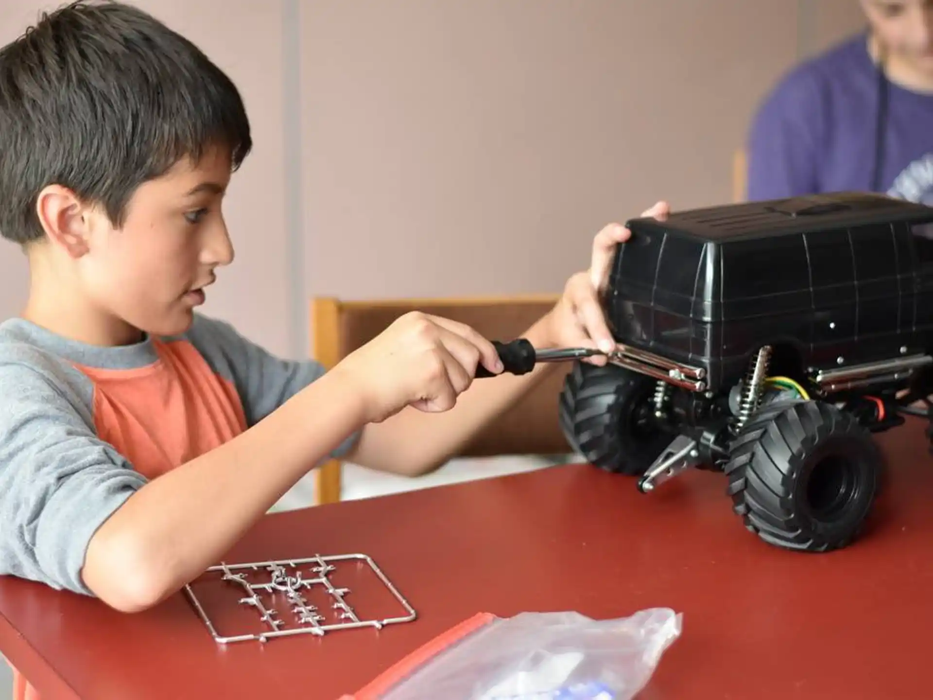 a young boy playing with a toy train