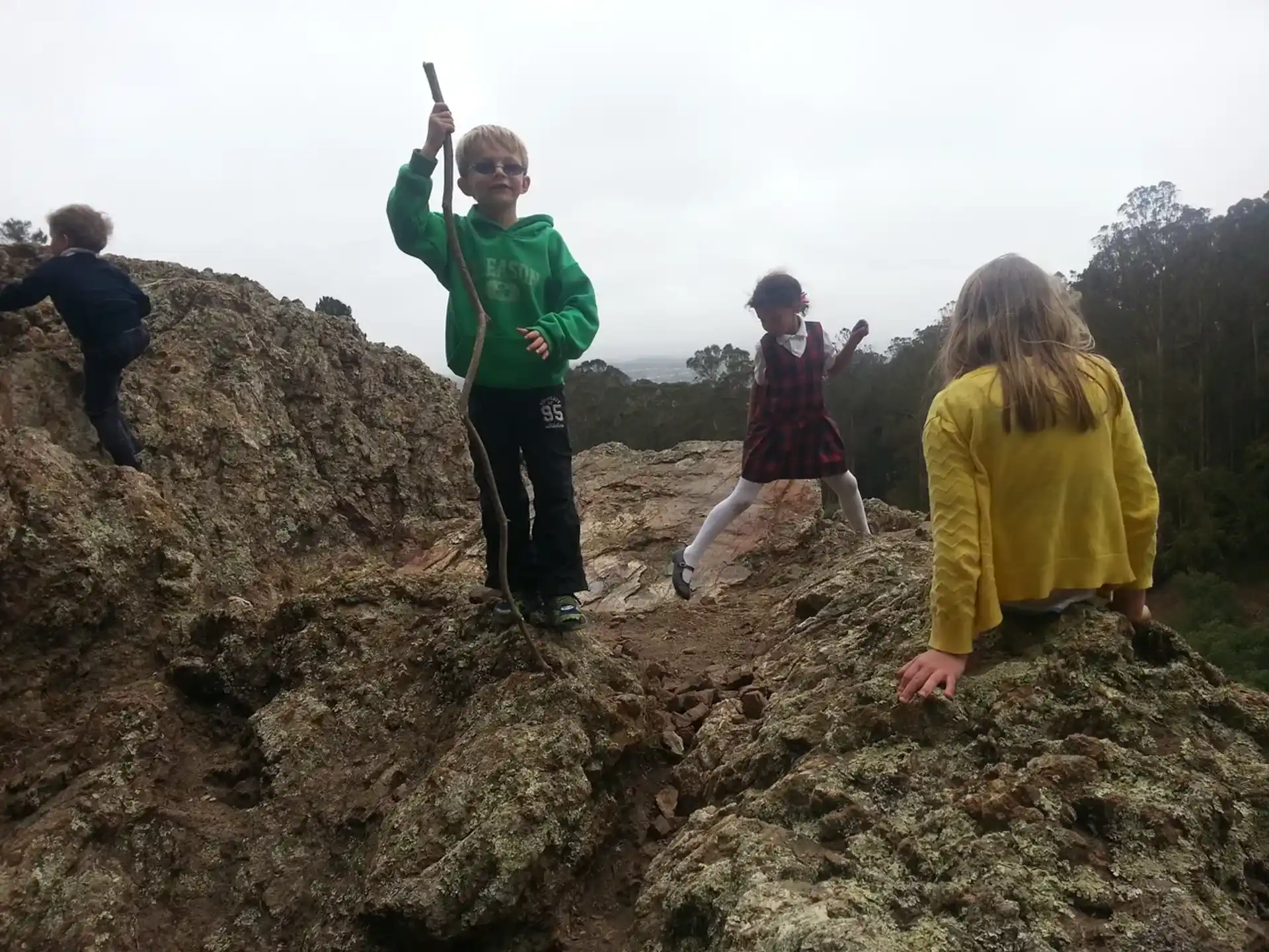 a group of people on a rocky hill
