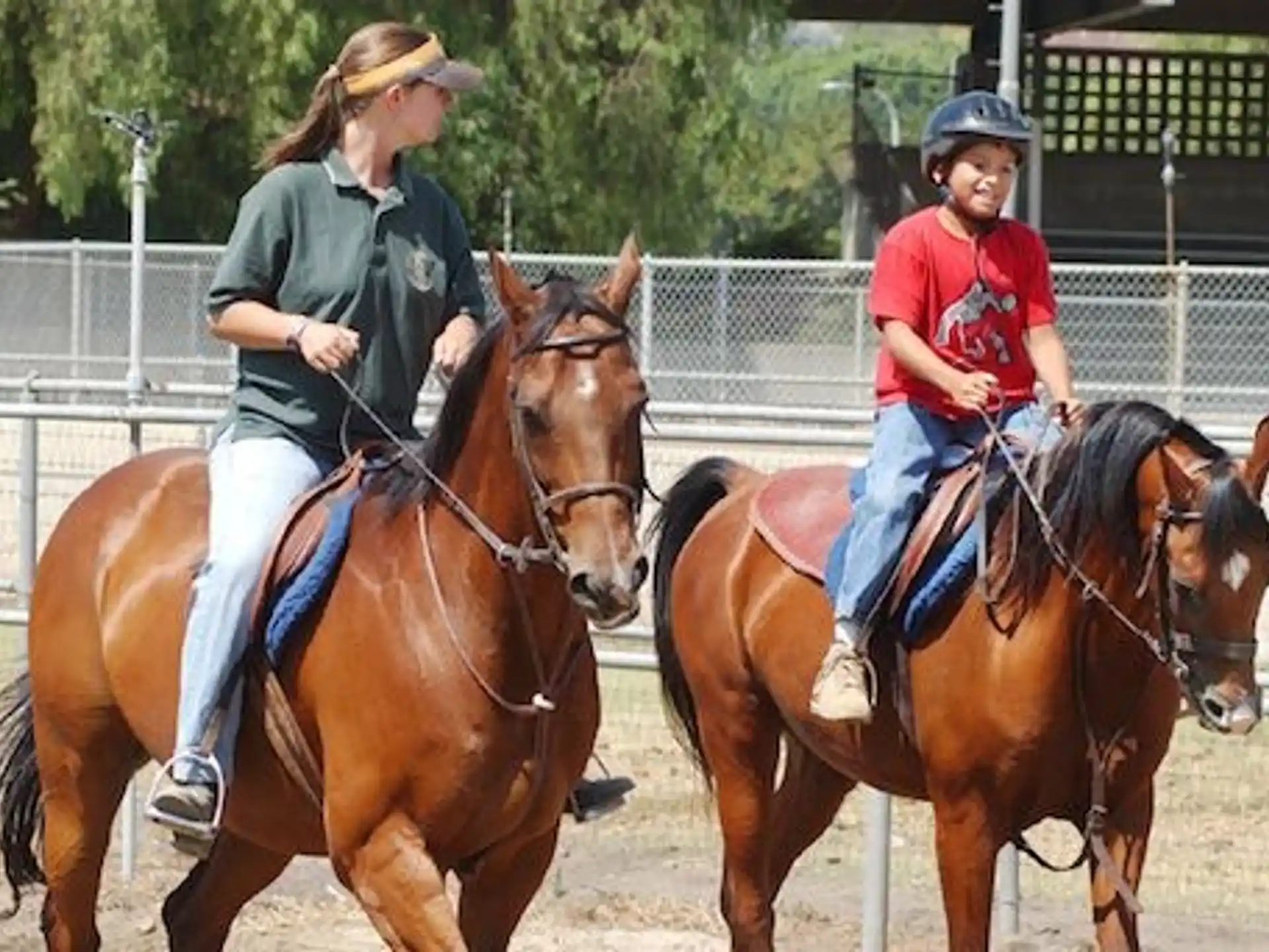 a couple of women riding horses