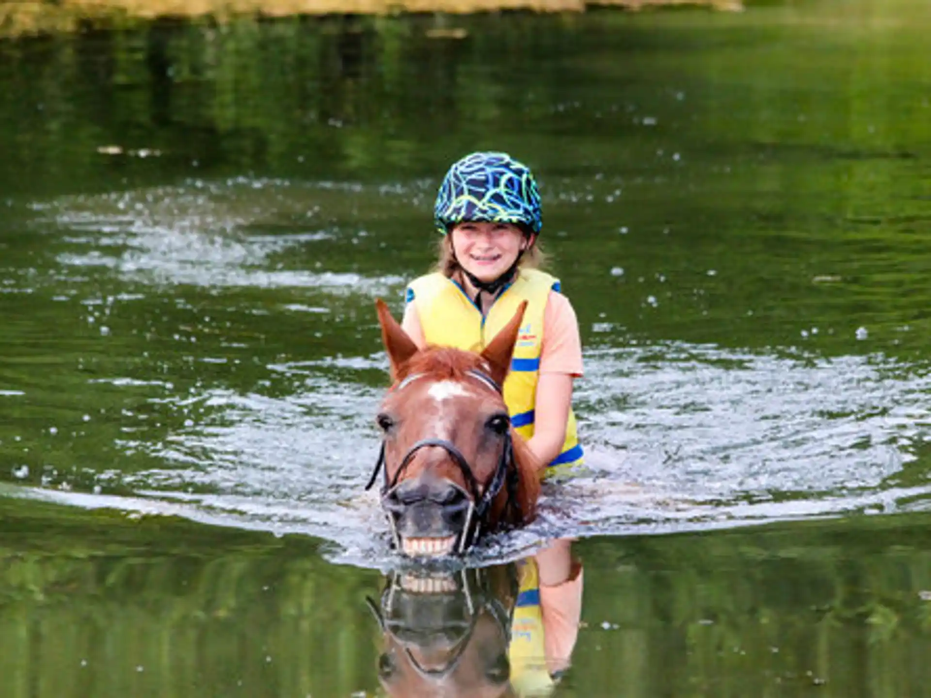 a person riding a horse in the water