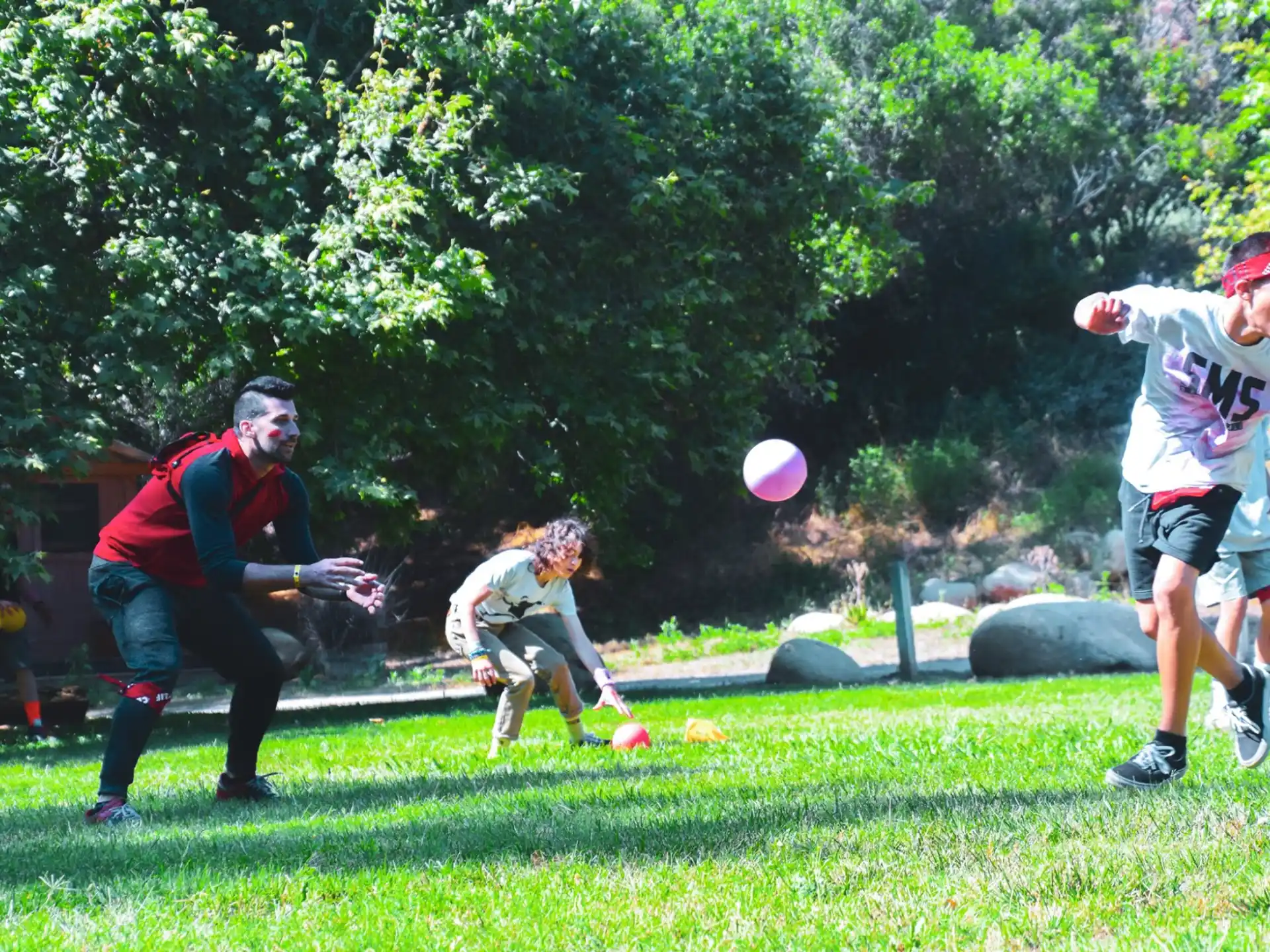 a group of people playing frisbee