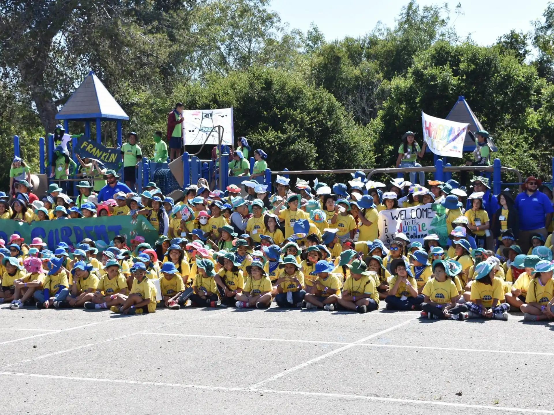 a group of people sitting on a track holding flags