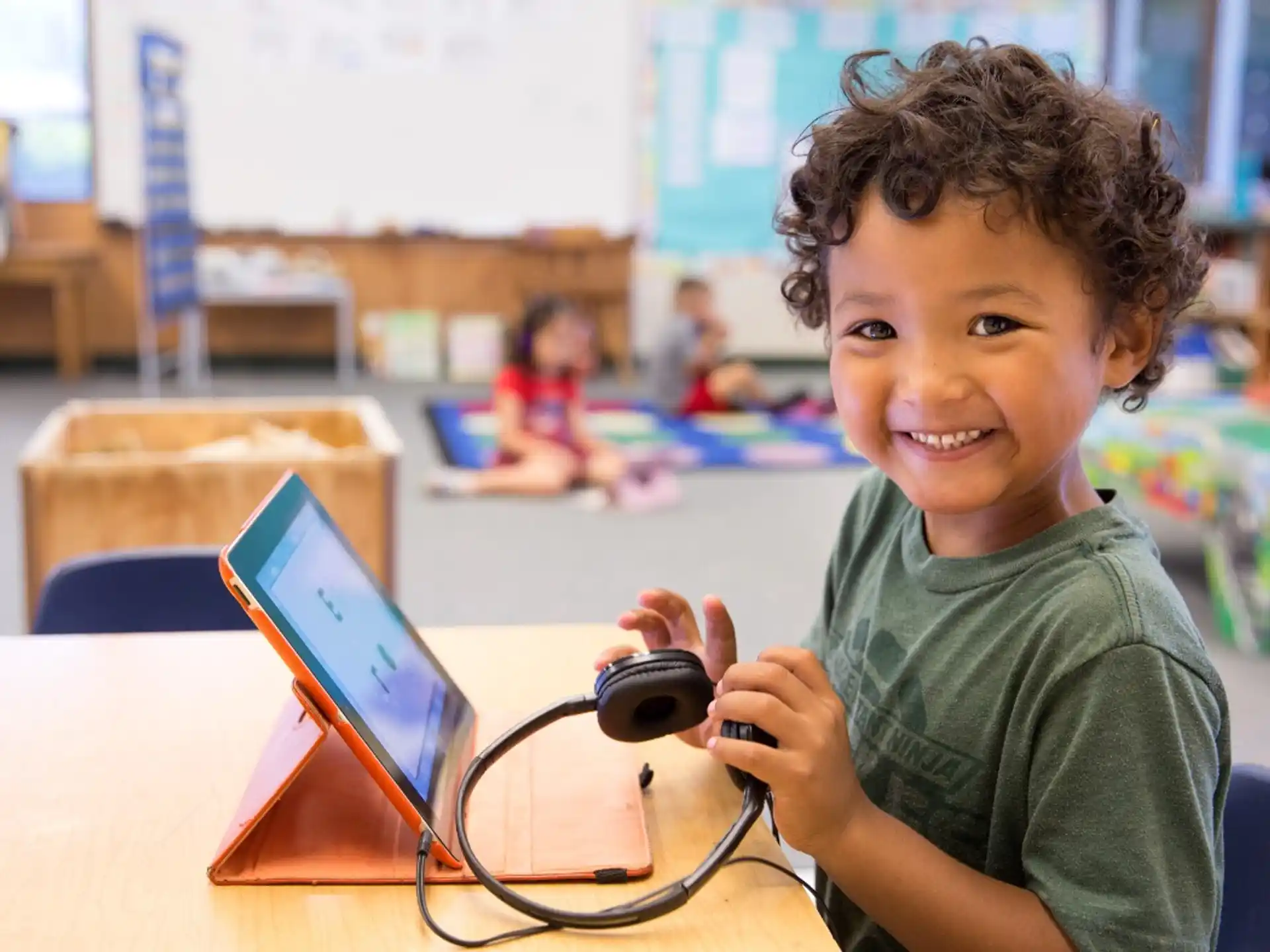 a young boy holding a device