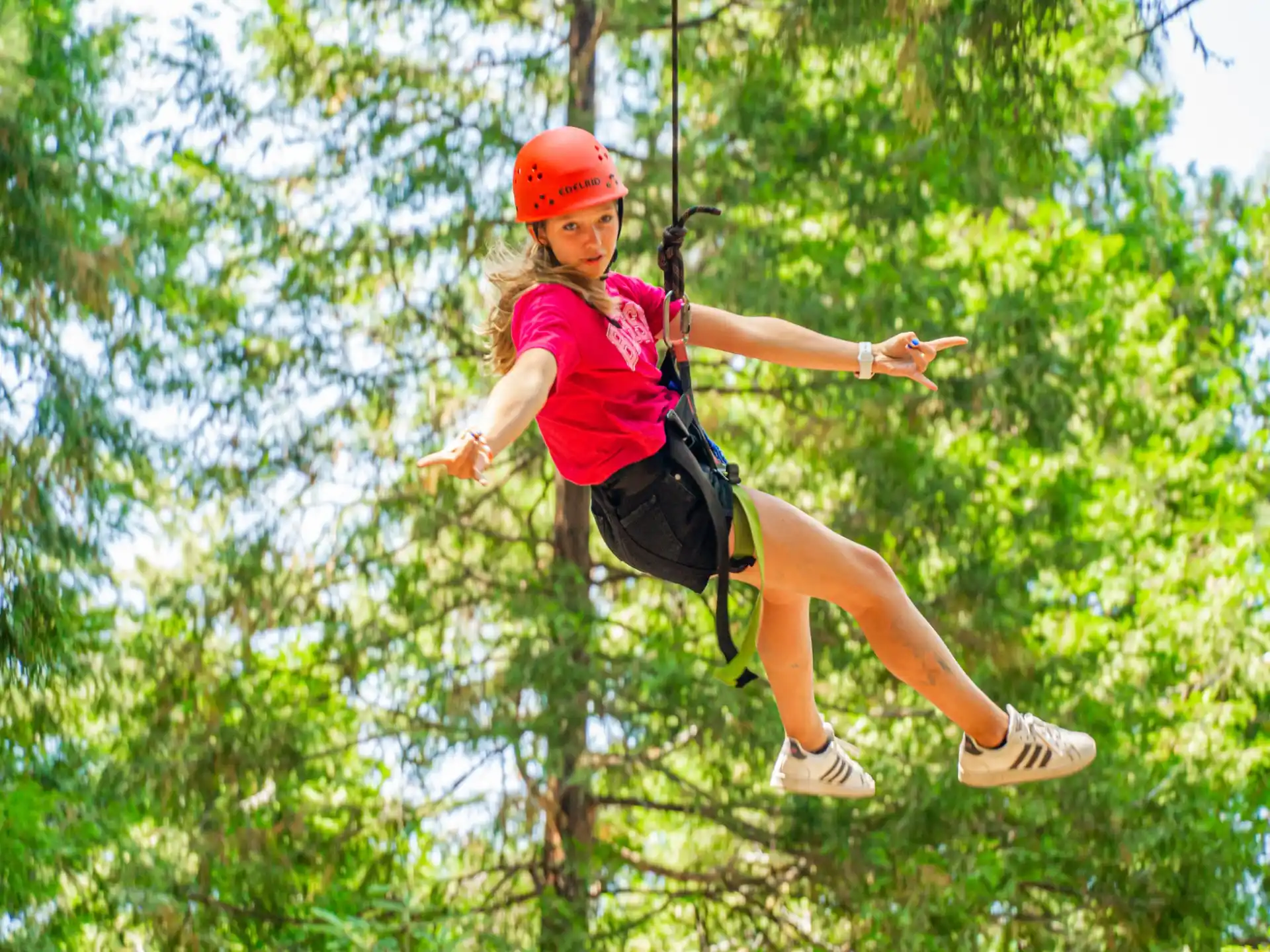 a person wearing a helmet and climbing a tree