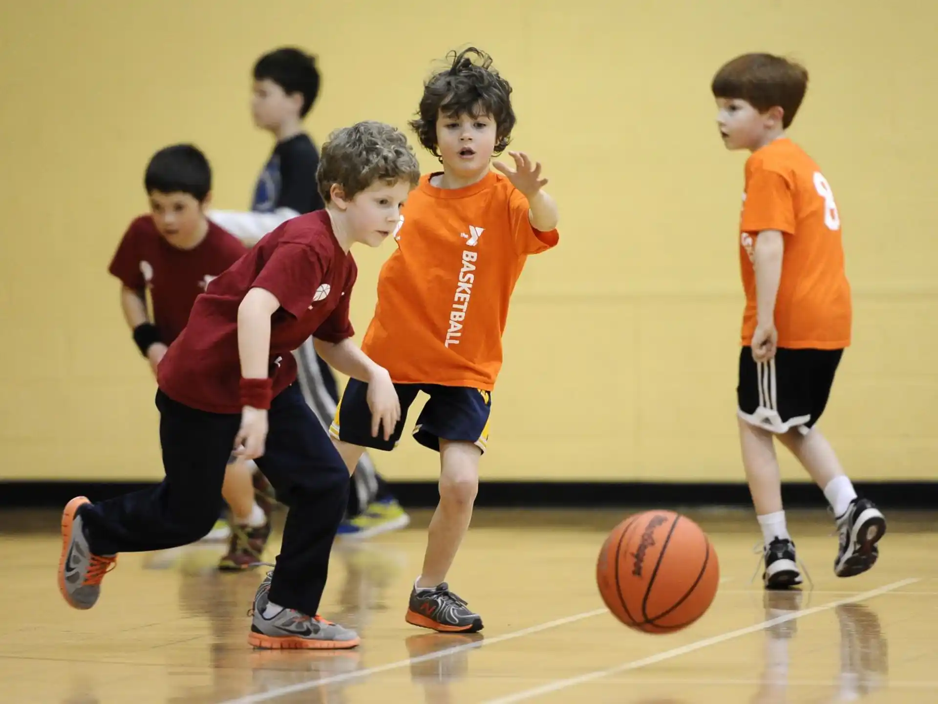 a group of kids playing basketball