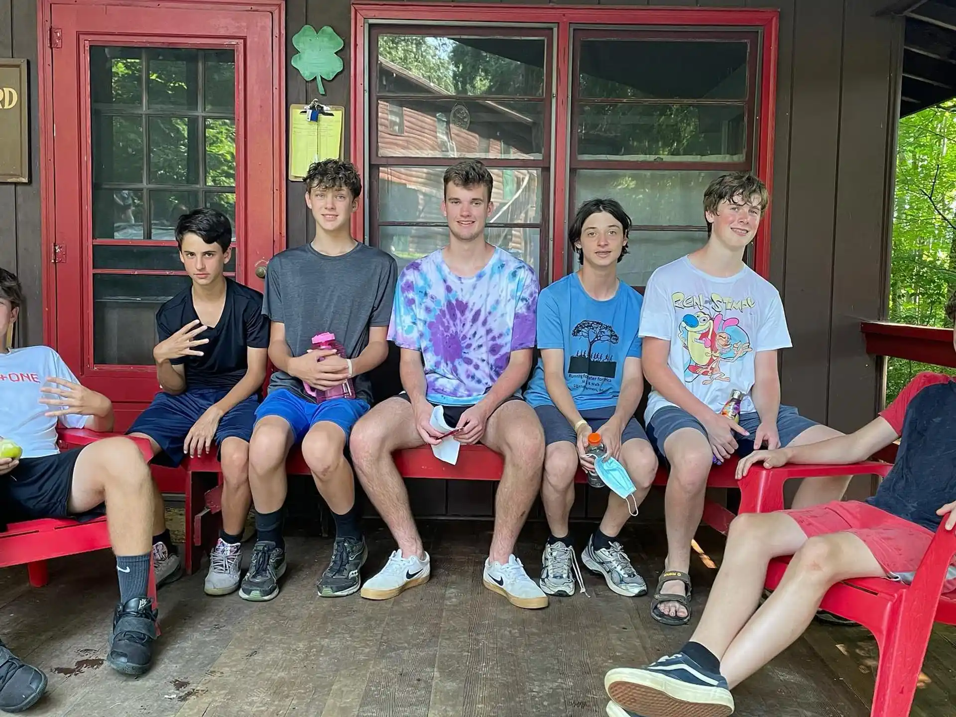 a group of people sitting on a bench outside a building