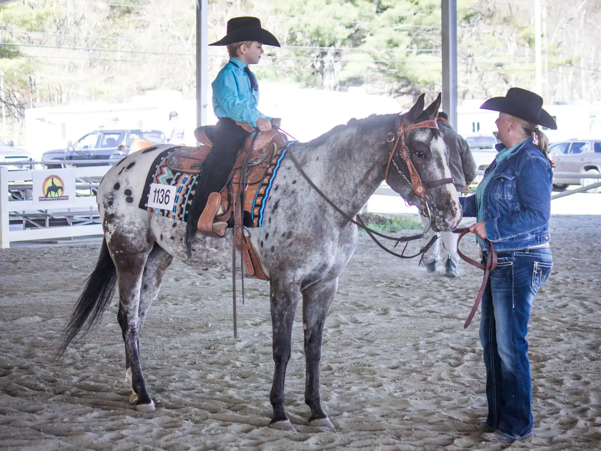 a man on a horse being led by a man