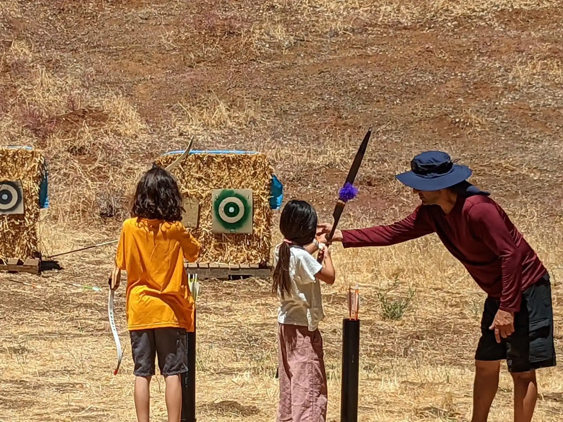 a person and kids playing baseball