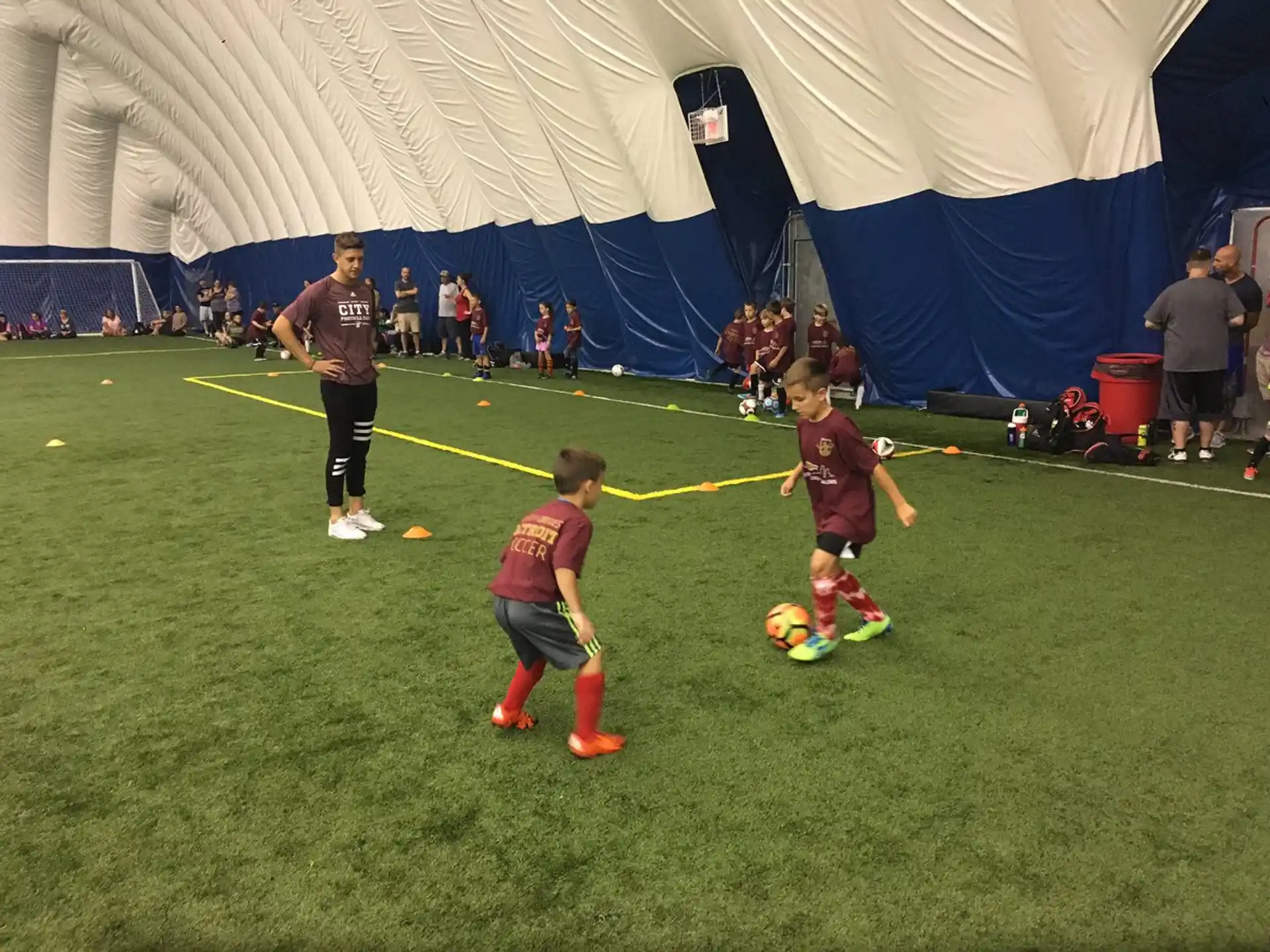 kids playing football under a tent